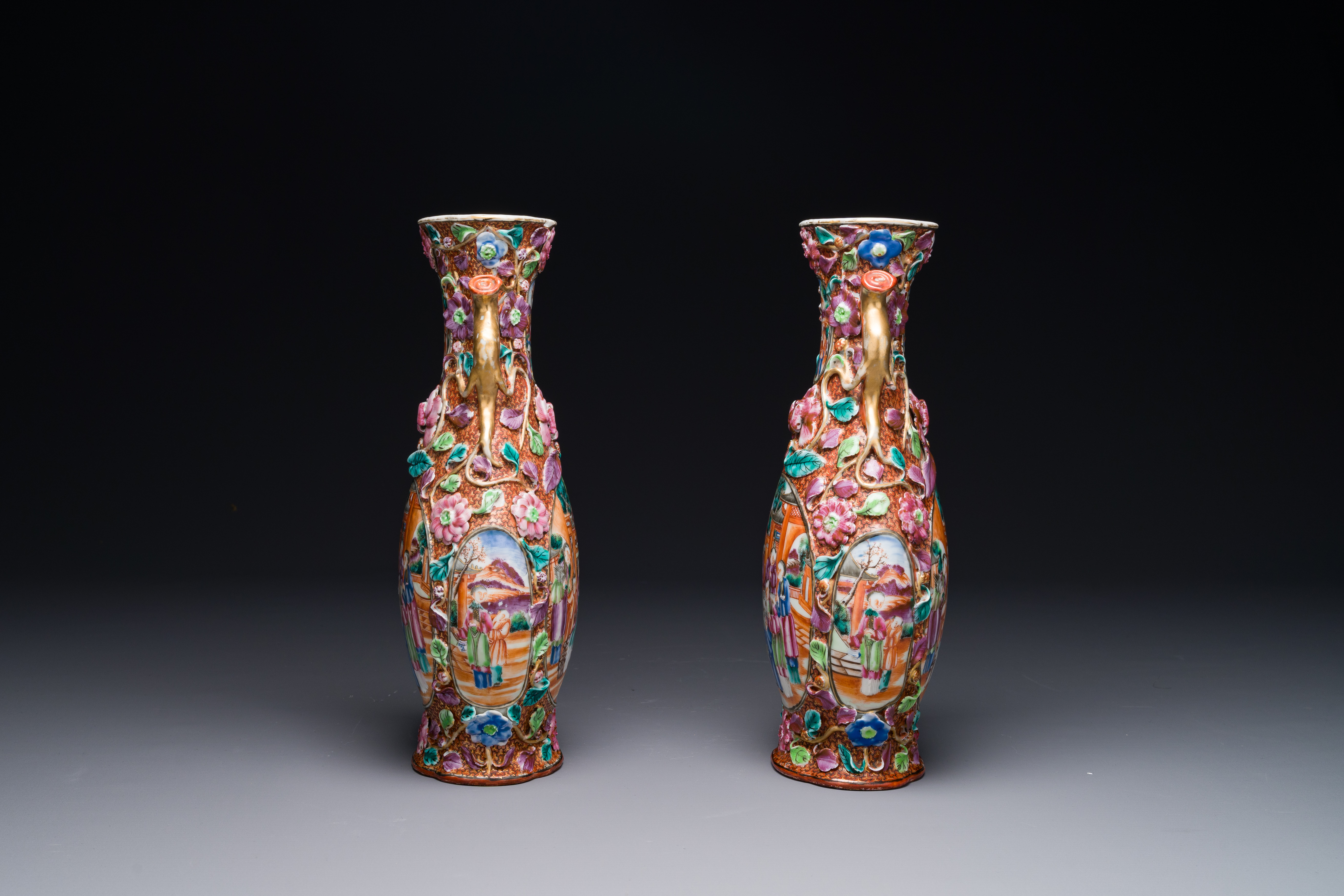 A pair of Chinese Canton famille rose 'mandarin subject' vases with floral relief design, Qianlong - Image 2 of 6
