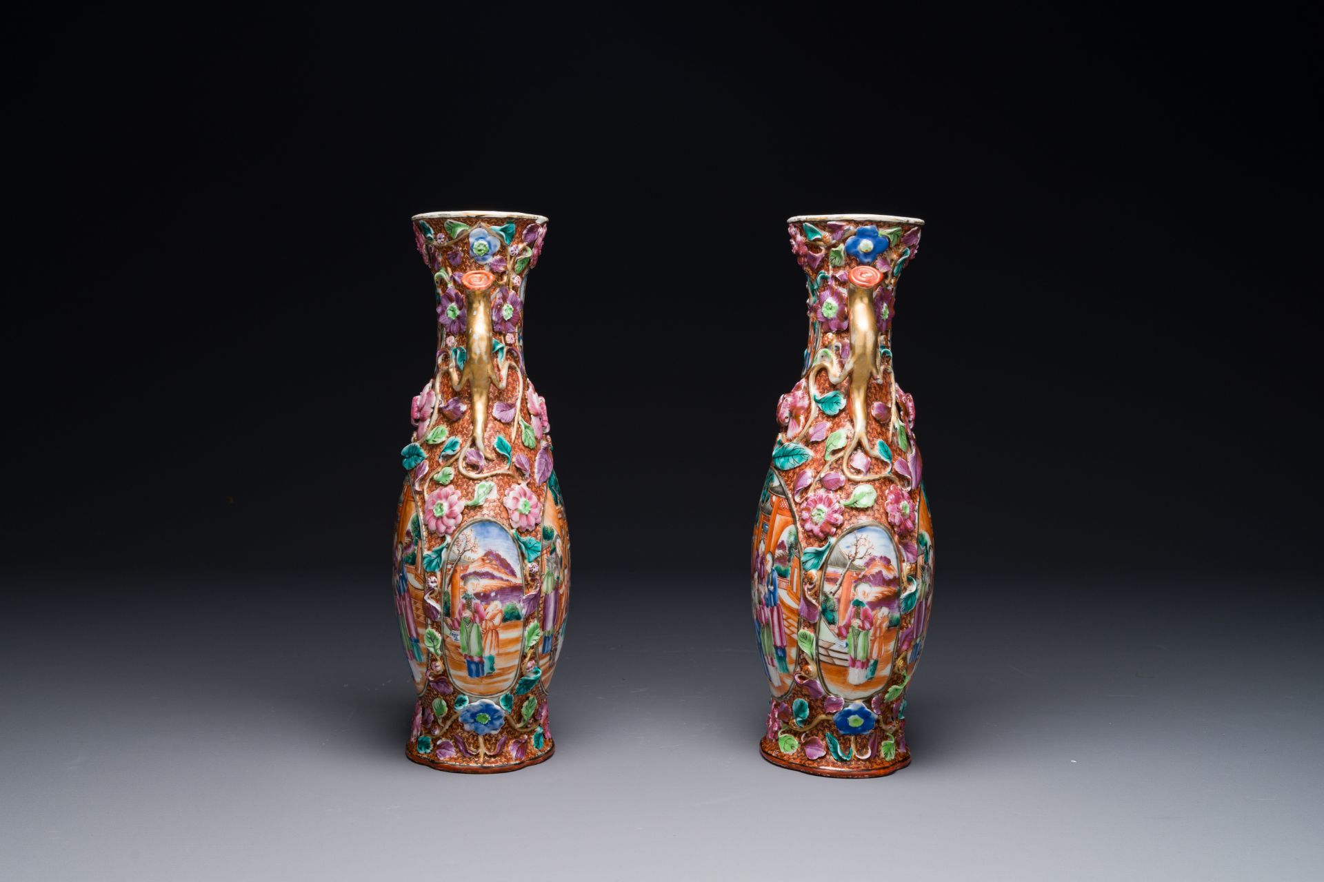 A pair of Chinese Canton famille rose 'mandarin subject' vases with floral relief design, Qianlong - Image 2 of 6