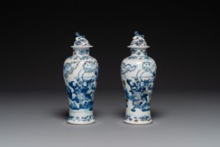 A pair of Chinese blue, white and copper-red vases and covers, Kangxi mark, 19th C.