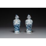 A pair of Chinese blue, white and copper-red vases and covers, Kangxi mark, 19th C.