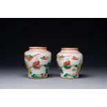 A pair of small Chinese wucai jars with figures in a landscape, Transition period