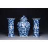 A Chinese blue and white garniture of three vases with floral and landscape design, Kangxi