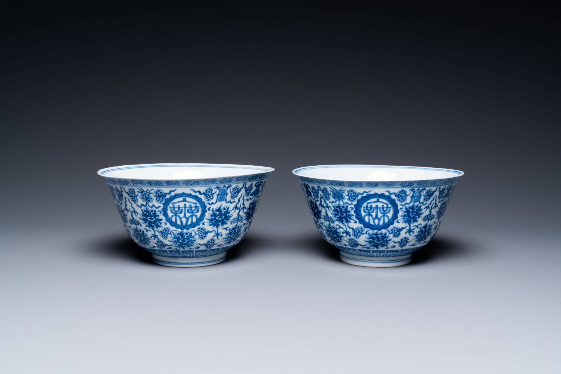 A pair of Chinese blue and white 'wan shou wu jiang' bowls, Qianlong mark and of the period