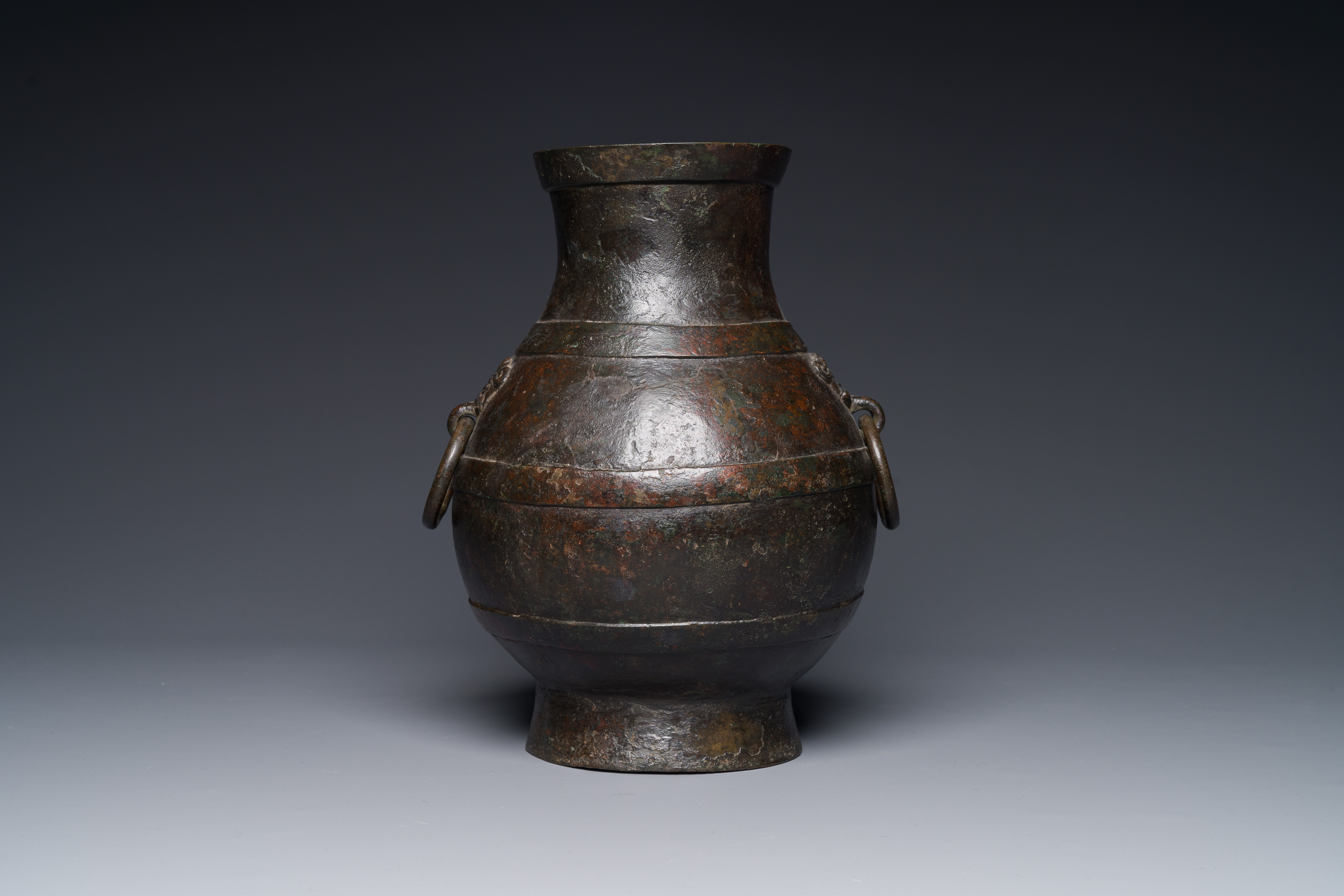 A Chinese bronze 'hu' vase with Han-style taotie handles on wooden base, Ming - Image 7 of 12