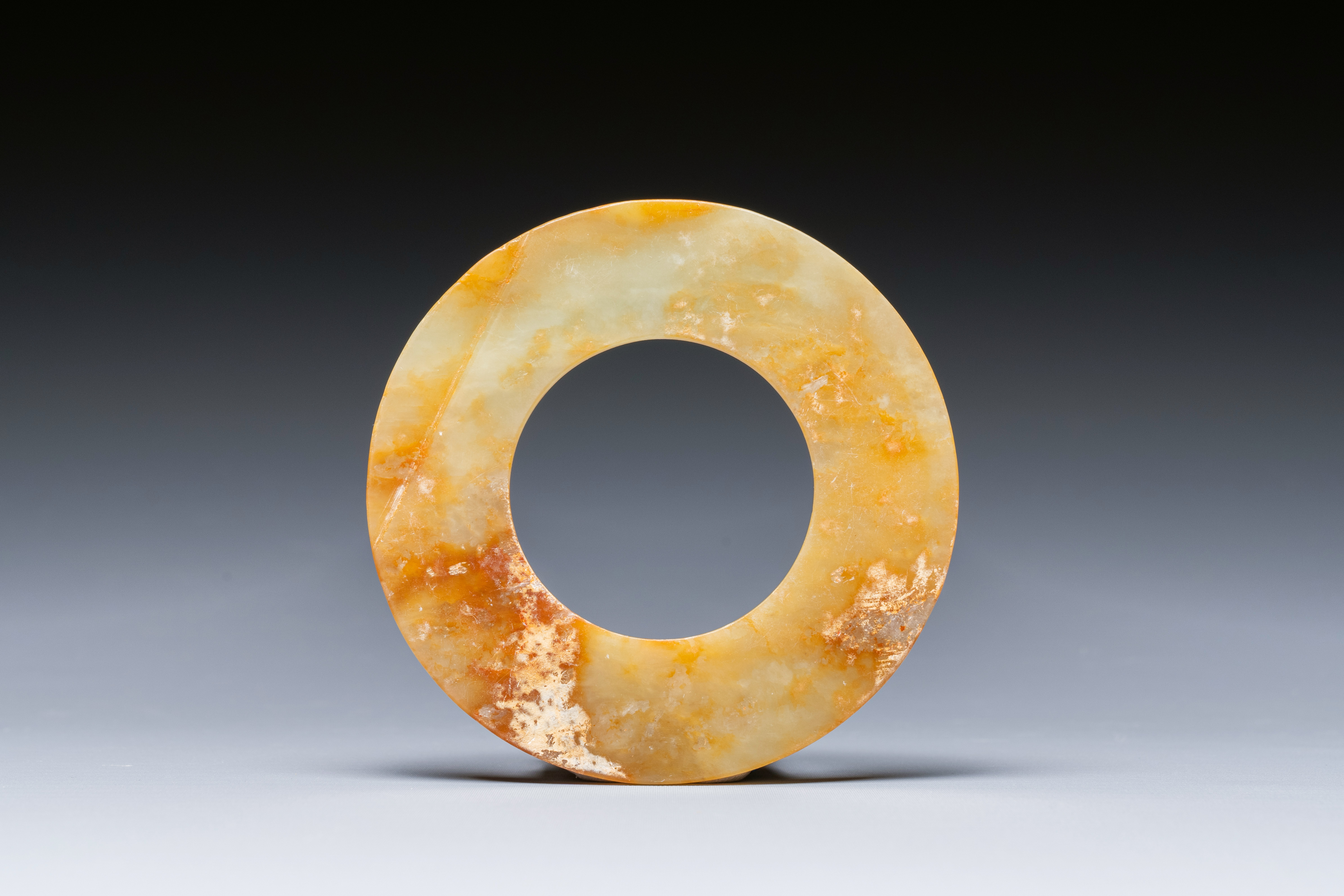 A Chinese celadon and russet jade 'bi' disc, probably Han - Image 2 of 4