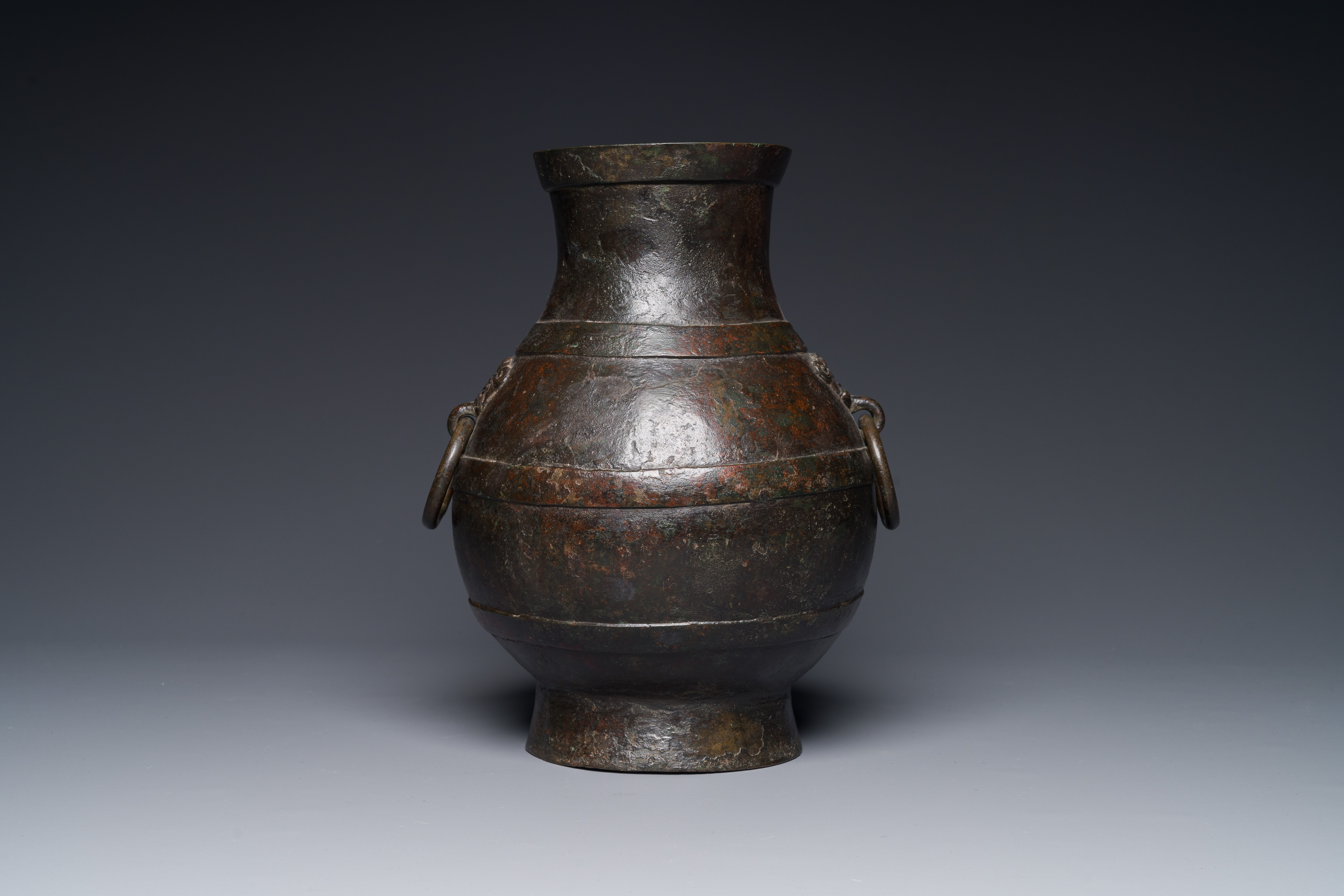 A Chinese bronze 'hu' vase with Han-style taotie handles on wooden base, Ming - Image 9 of 12