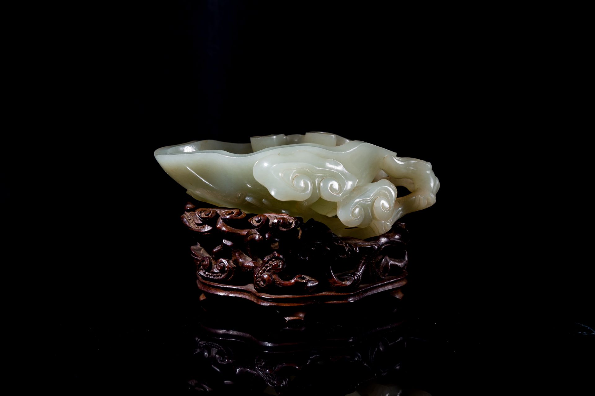 A Chinese celadon jade brush washer on wooden stand, 19/20th C.