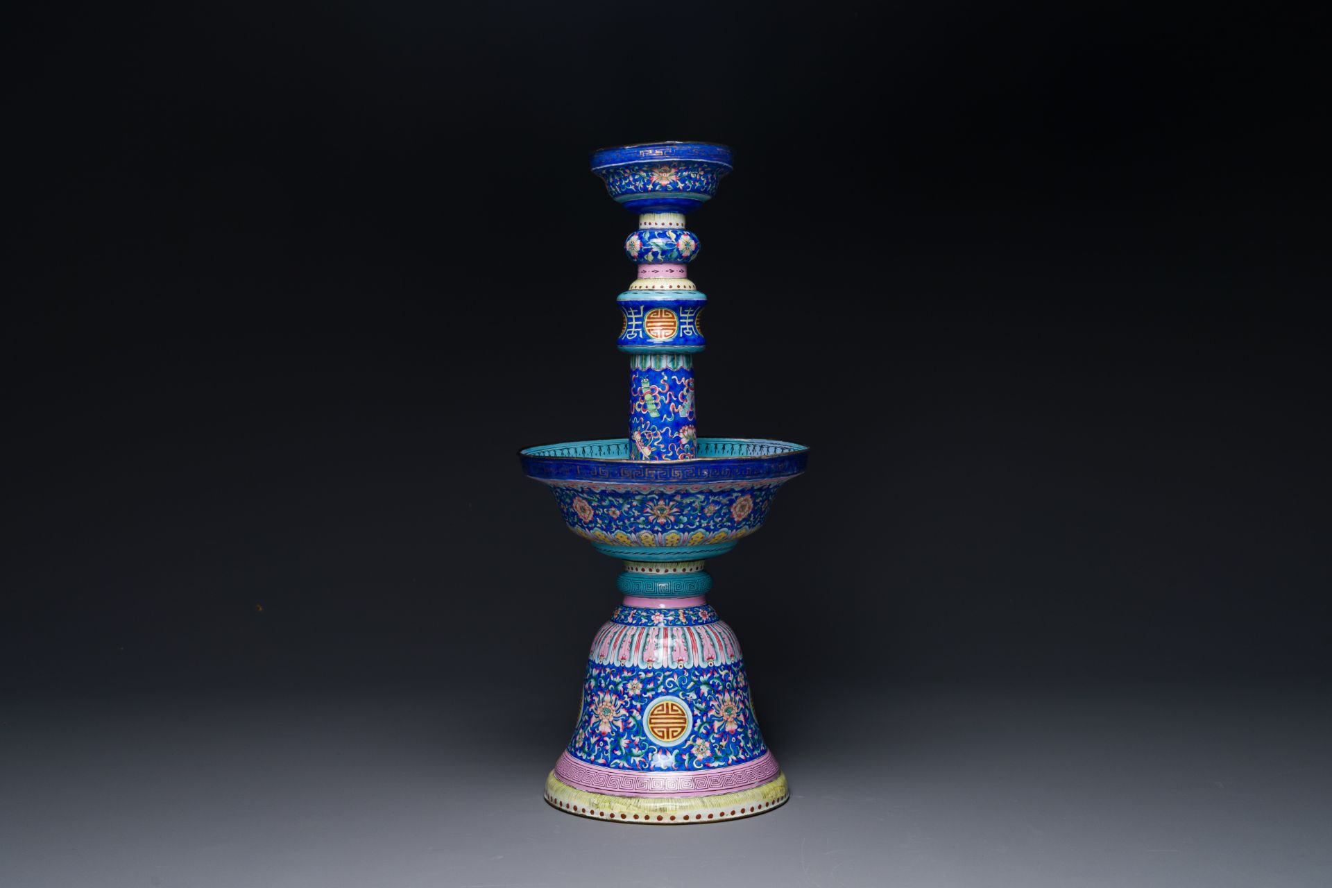 A large Chinese Canton enamel blue-ground 'shou' candlestick, Qianlong/Jiaqing