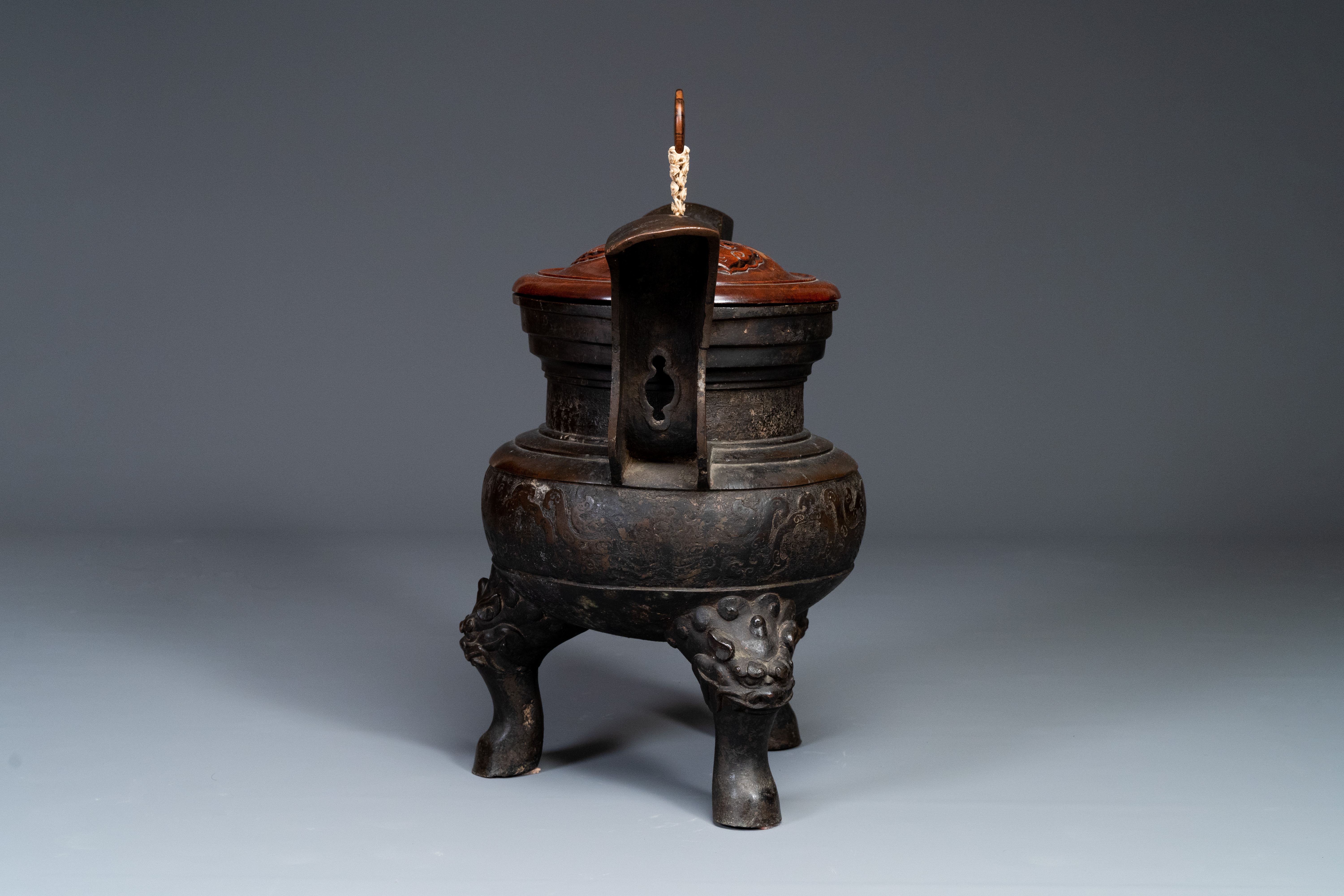 An important Chinese bronze tripod 'taotie' censer with wooden lid, Ming - Image 6 of 18