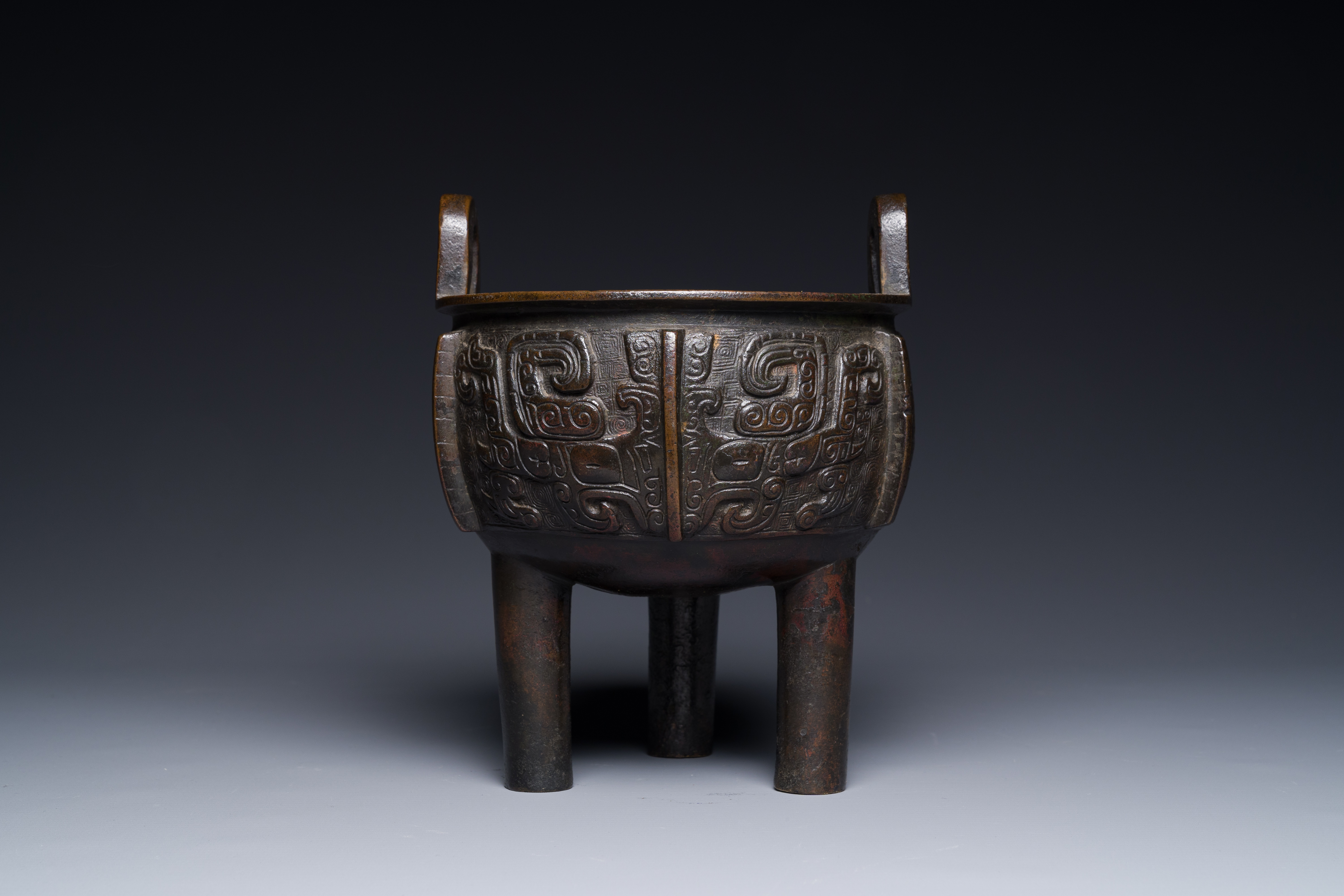 A Chinese archaistic bronze tripod censer on wooden stand, 'ding', Song/Ming - Image 12 of 21