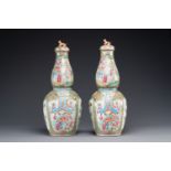 A pair of Chinese Canton famille rose double gourd vases and covers, 19th C.