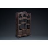 A richly carved Chinese hongmu wooden etagere cupboard, Canton, 19th C.