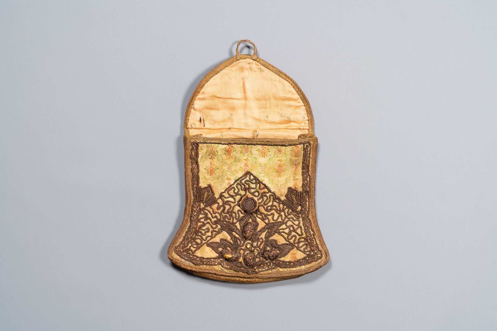 An Iranian gold-thread-embroidered silk caftan, a hat, a coin bracelet and a Koran holder, 19th C. - Image 7 of 7