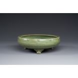 A Chinese Longquan celadon tripod censer on wooden stand, Yuan/Ming