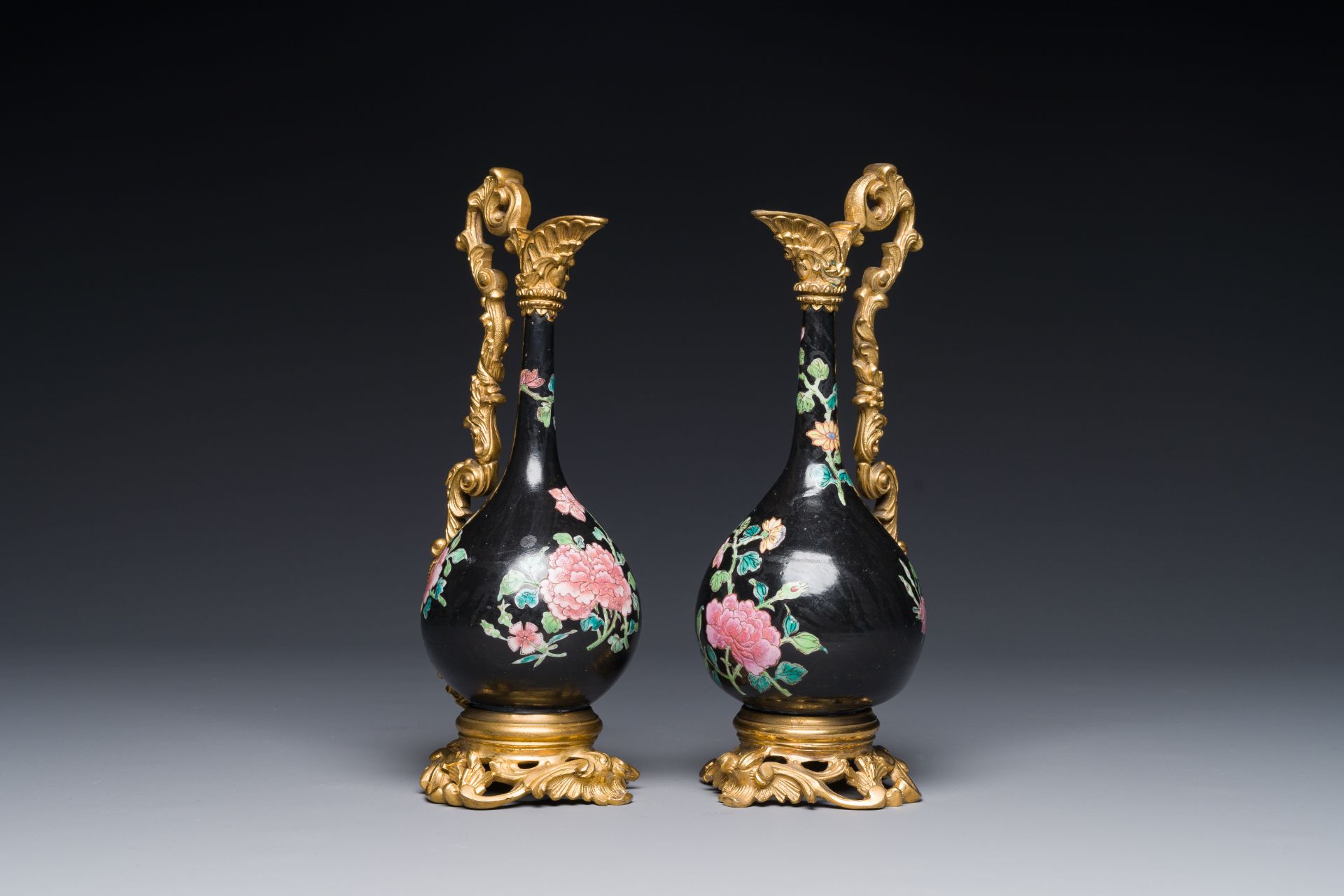 A pair of Chinese black-ground famille rose vases with gilt bronze mounts, Yongzheng