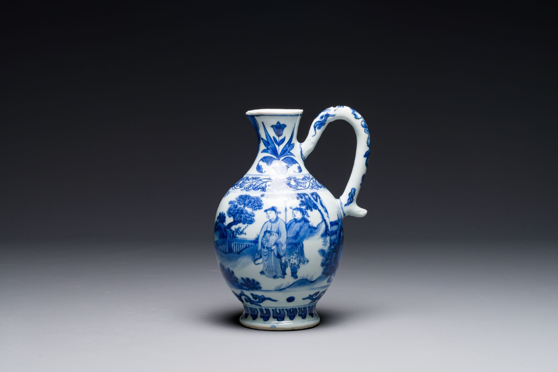 A Chinese blue and white ewer with figures in a landscape, Transitional period