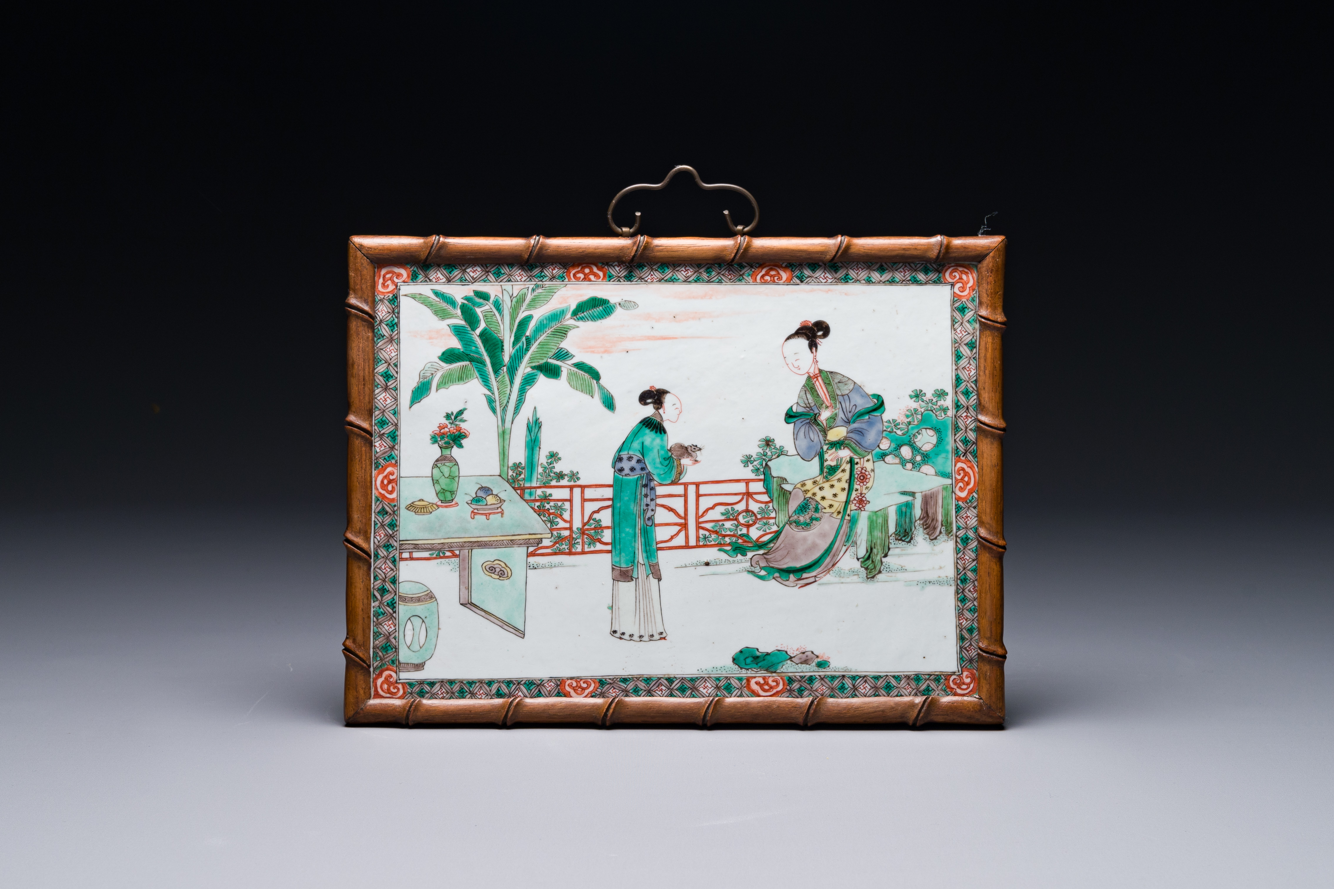 A Chinese rectangular famille verte plaque in wooden faux bamboo frame, Kangxi