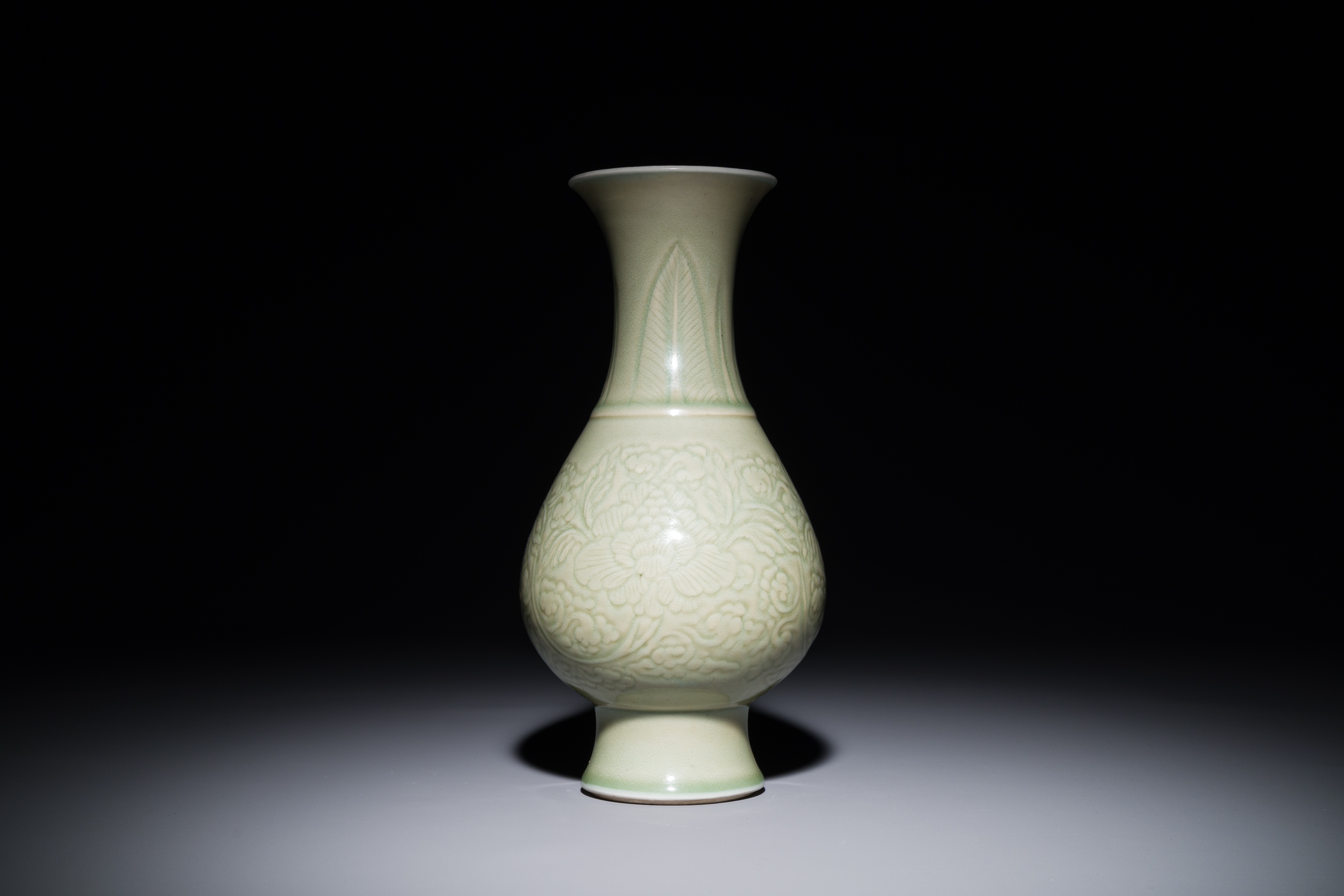 A Chinese monochrome celadon-glazed vase with anhua floral design, Kangxi