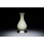 A Chinese monochrome celadon-glazed vase with anhua floral design, Kangxi