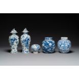 A pair of Chinese blue and white covered vases and three jars, 19th C.