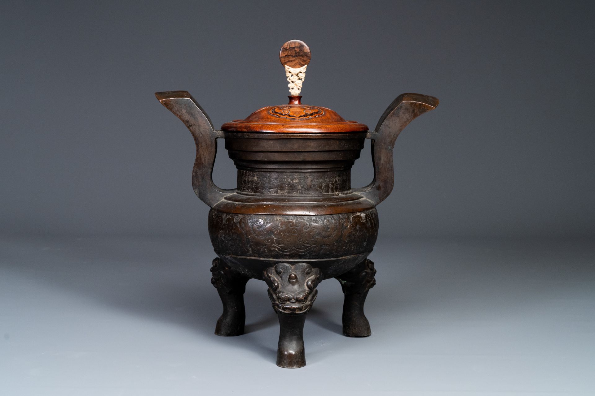 An important Chinese bronze tripod 'taotie' censer with wooden lid, Ming - Image 2 of 18