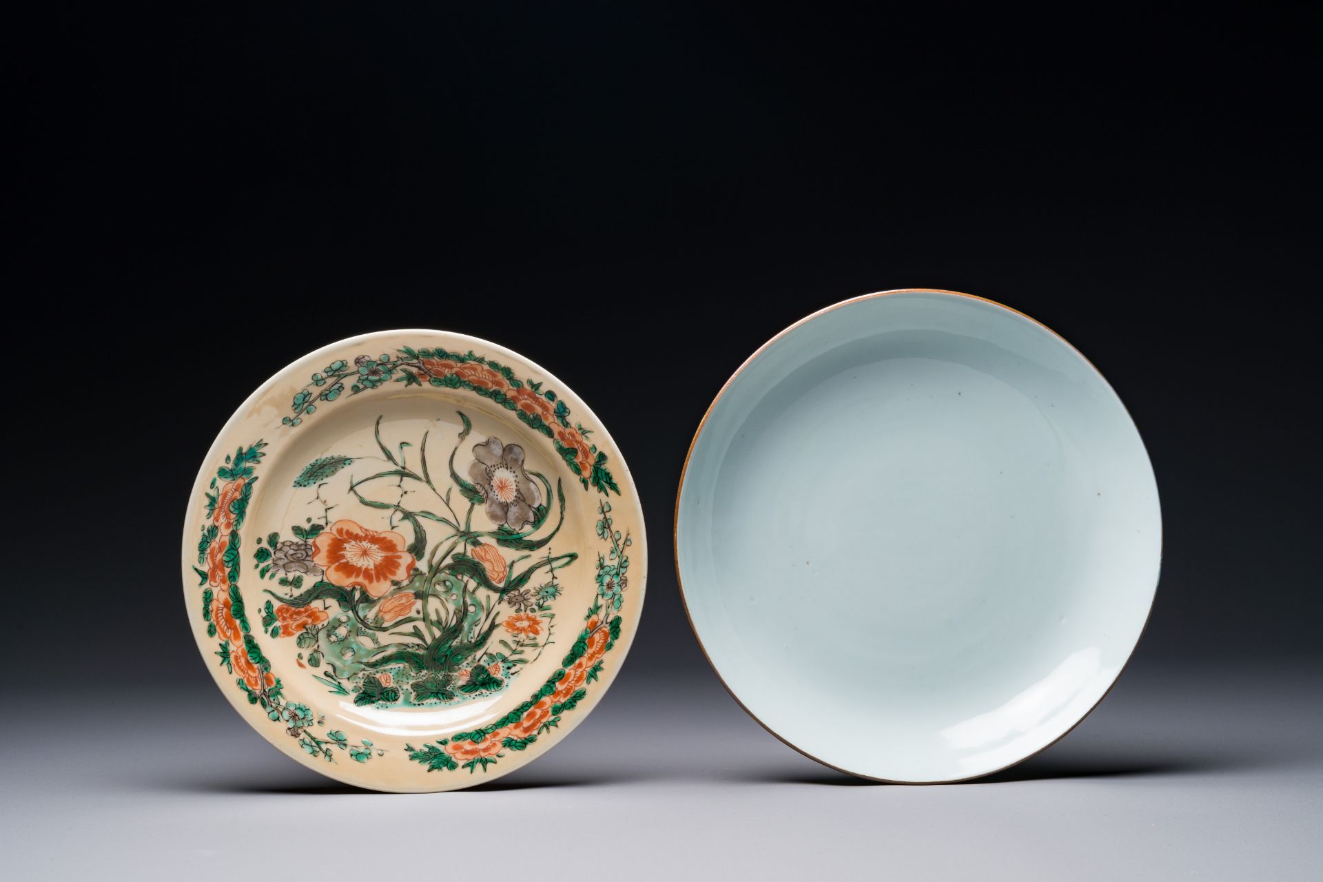 A Chinese famille verte cafe-au-lait ground plate and a monochrome white plate, Kangxi
