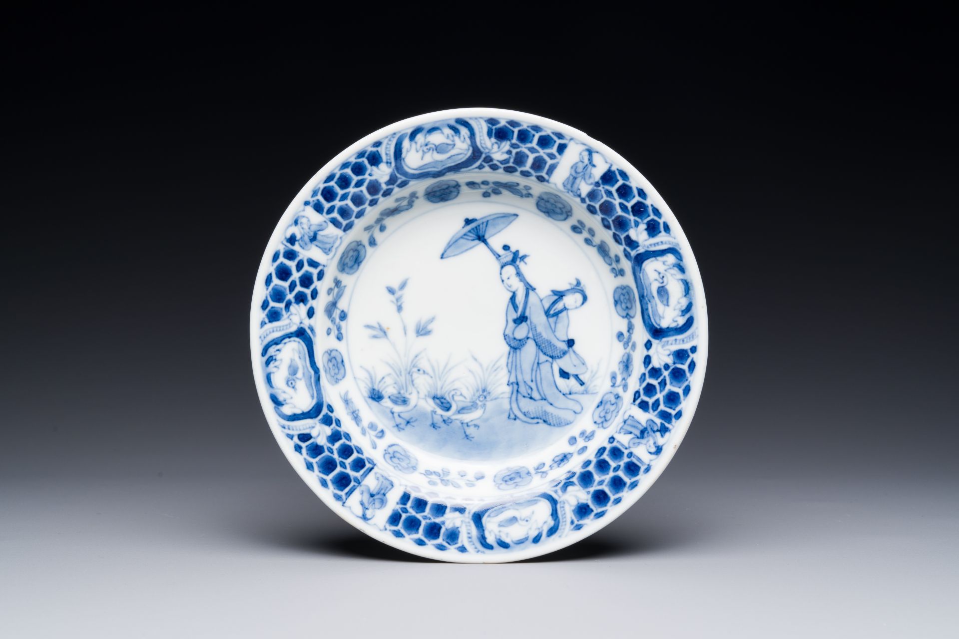 A Chinese blue and white plate with 'Parasol ladies' after Cornelis Pronk, Qianlong