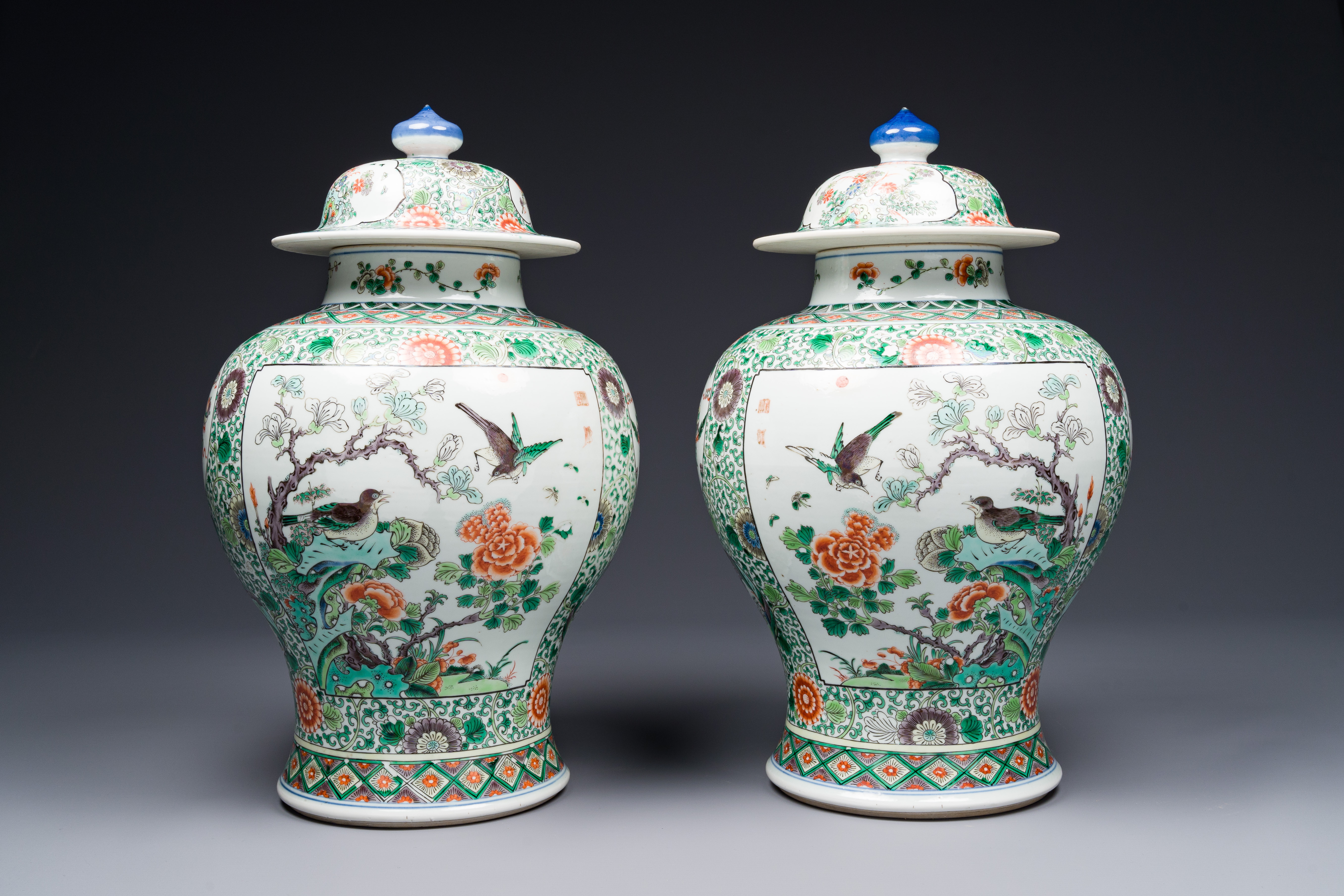 A pair of Chinese famille verte 'bird and flower' vases and covers, Kangxi mark, 19th C.