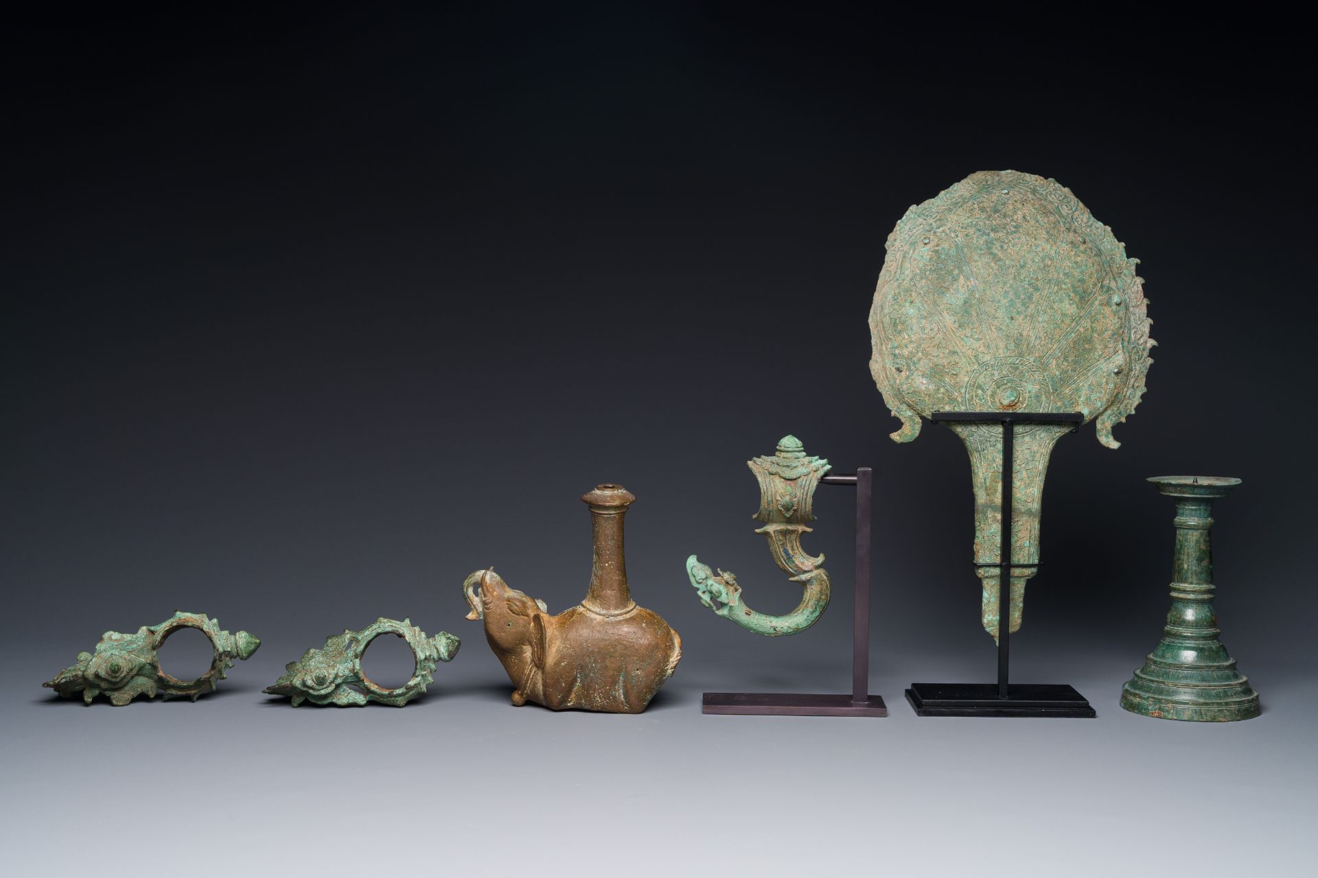 A collection of bronze sculptures, palanquin hooks and a candlestick holder, Cambodia, 13th C. and e - Image 7 of 15