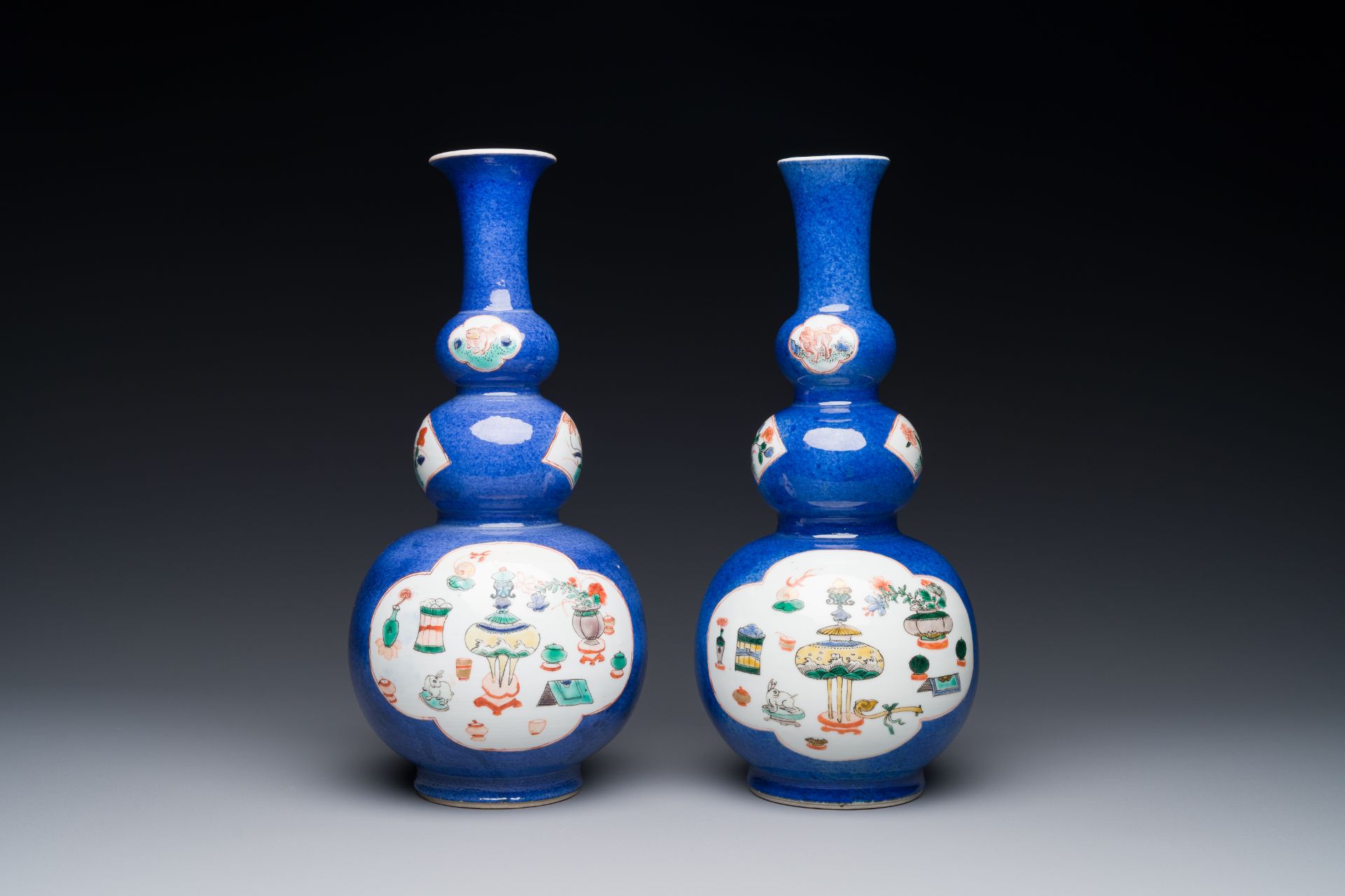 A pair of Chinese famille verte powder-blue-ground triple gourd 'antiquities' vases, Kangxi