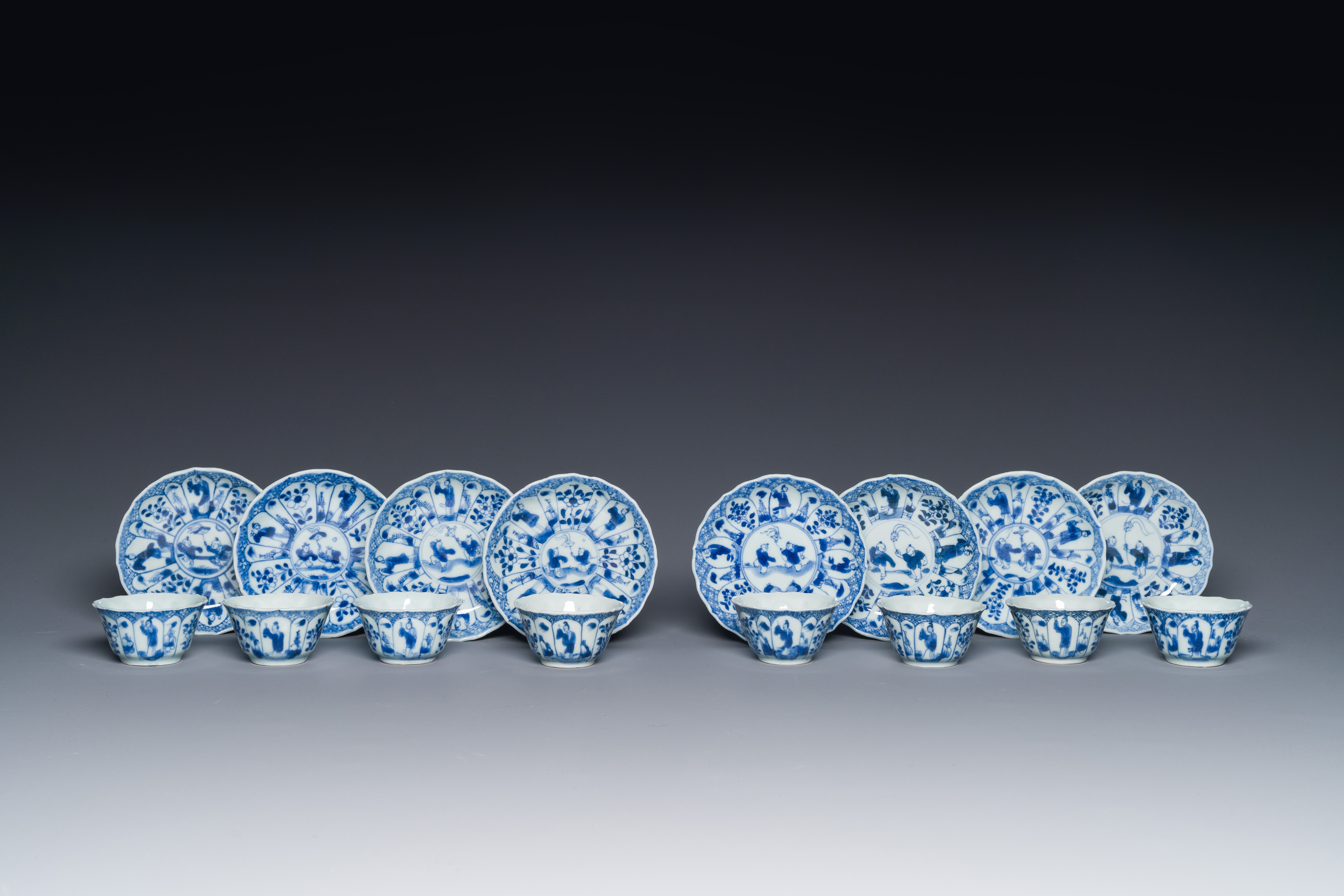 Eight Chinese blue and white 'kite flying boys' cups and saucers, Yongzheng