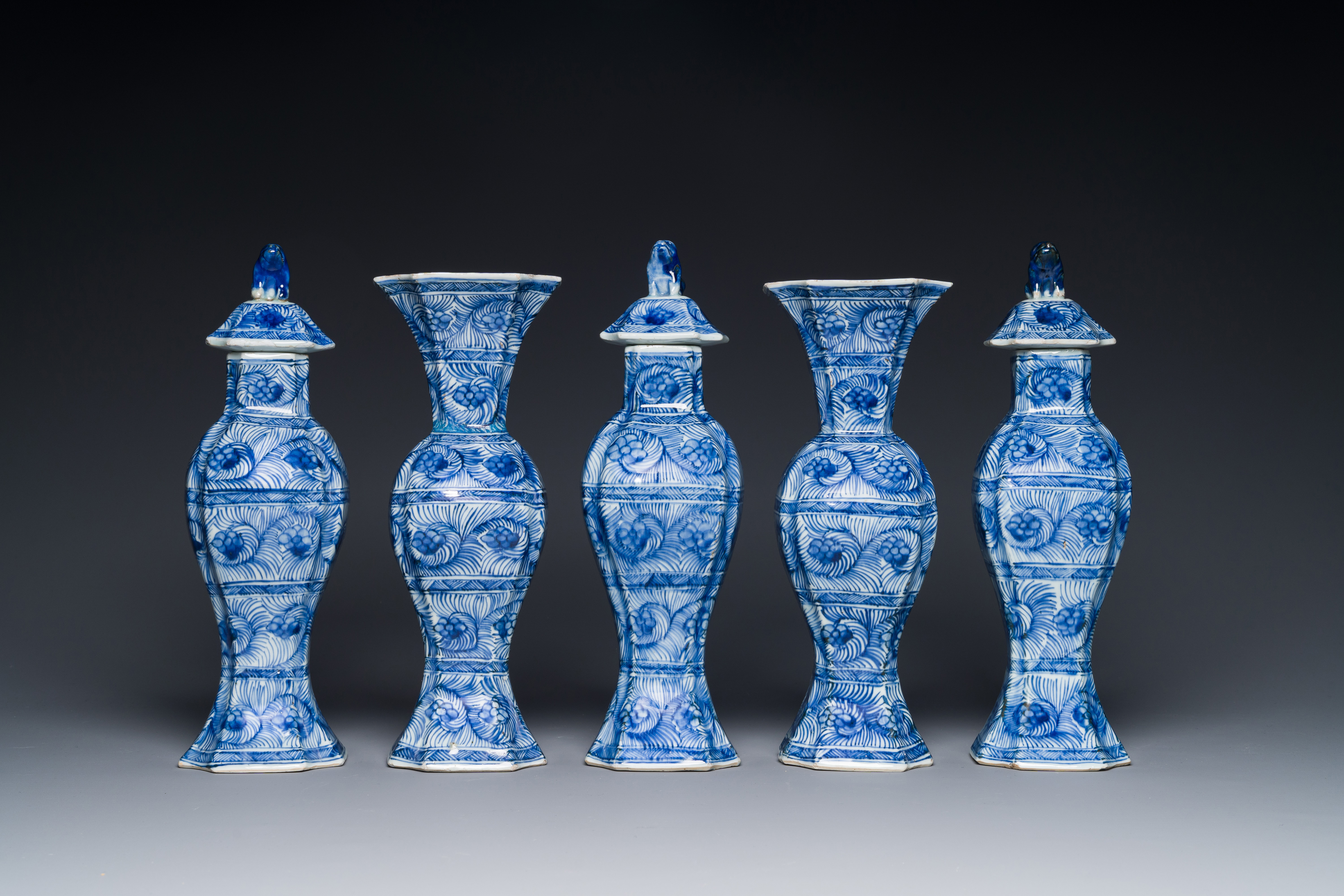 A Chinese blue and white garniture of five vases with floral design, Kangxi