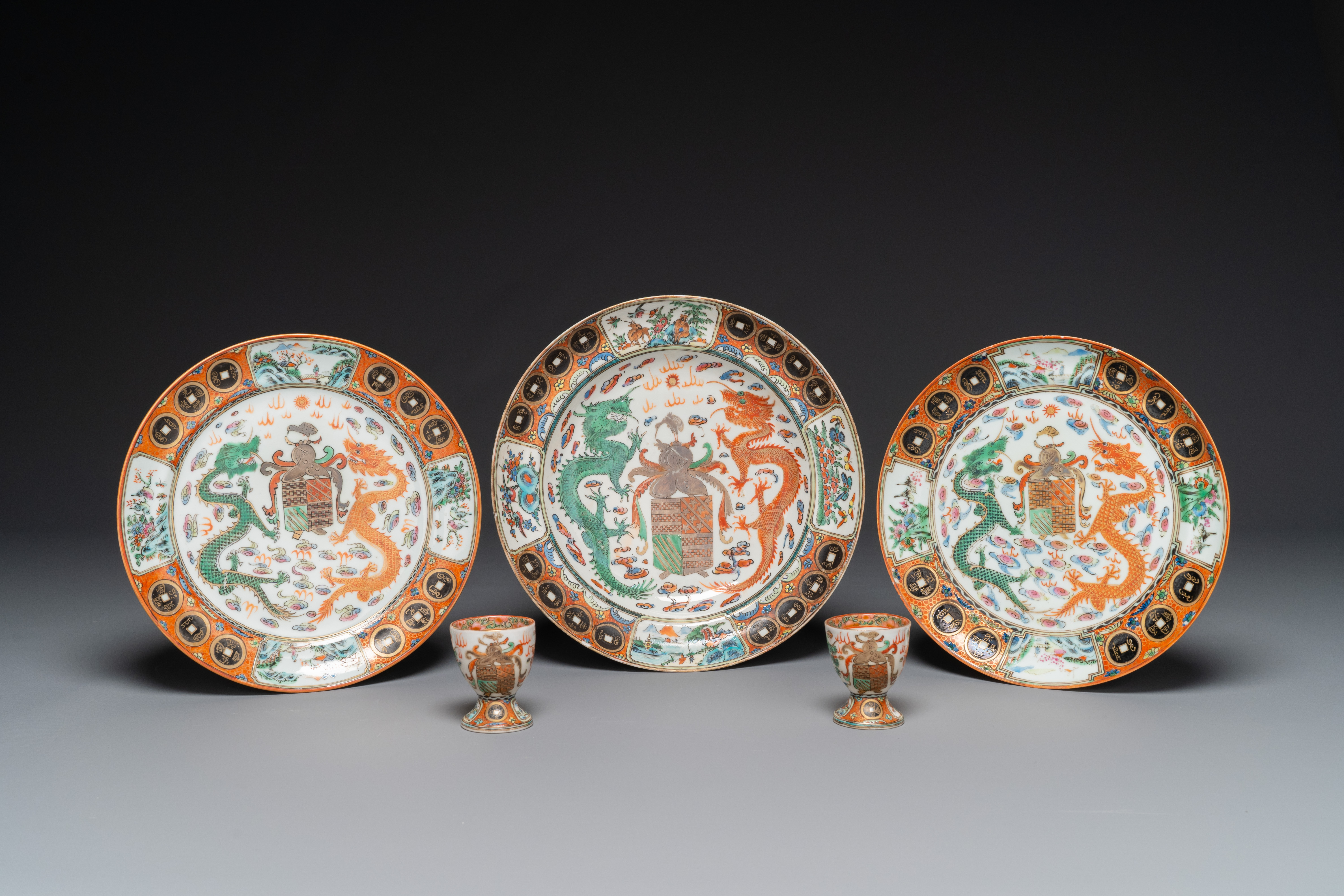 Three Chinese Canton famille rose armorial plates and a pair of egg cups for the Portugese market, G