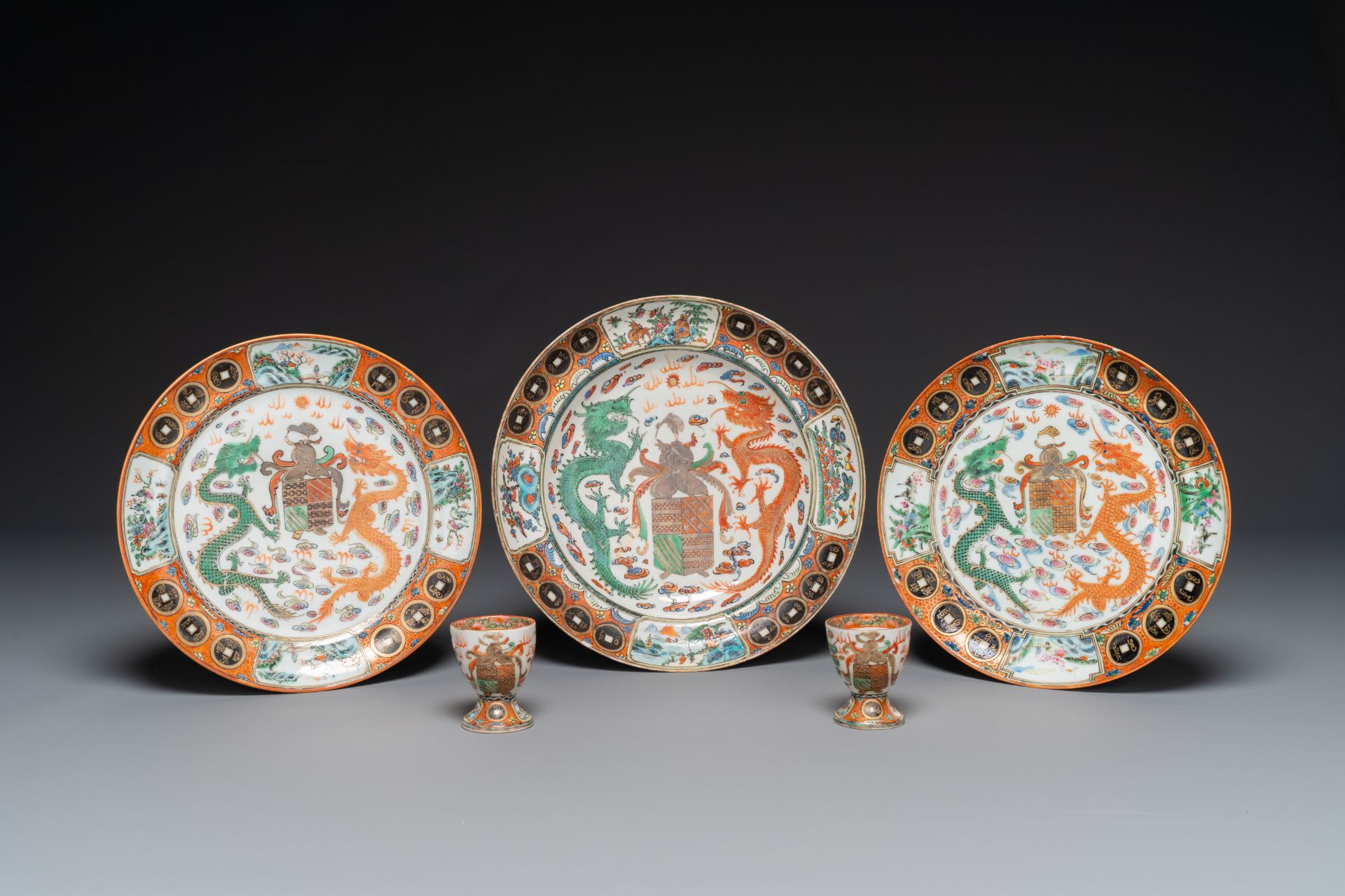 Three Chinese Canton famille rose armorial plates and a pair of egg cups for the Portugese market, G