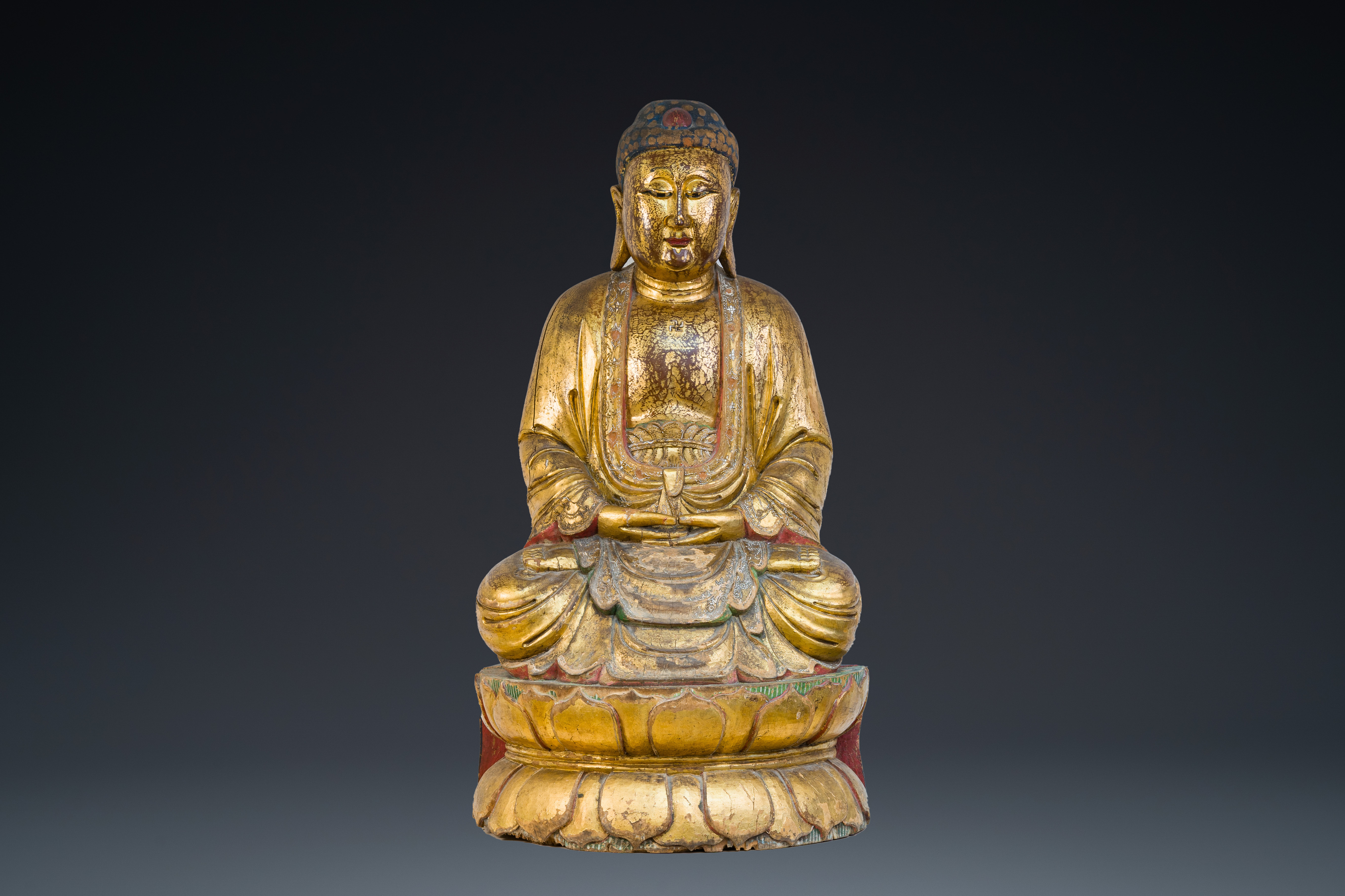 A large Chinese or Vietnamese gilded and polychromed wooden Buddha, 19th C.