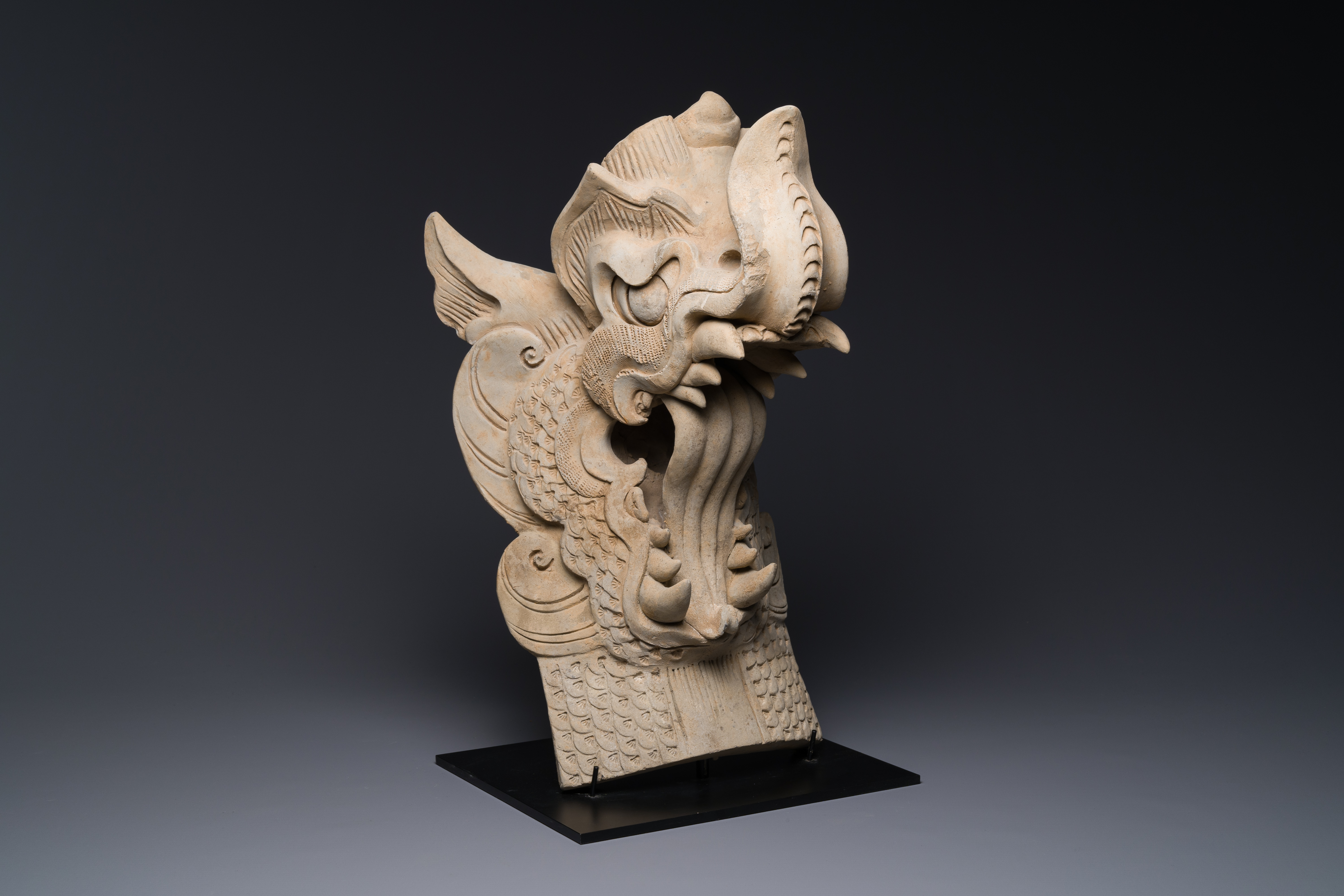 A Chinese pottery dragon head architectural tile, Song/Jin