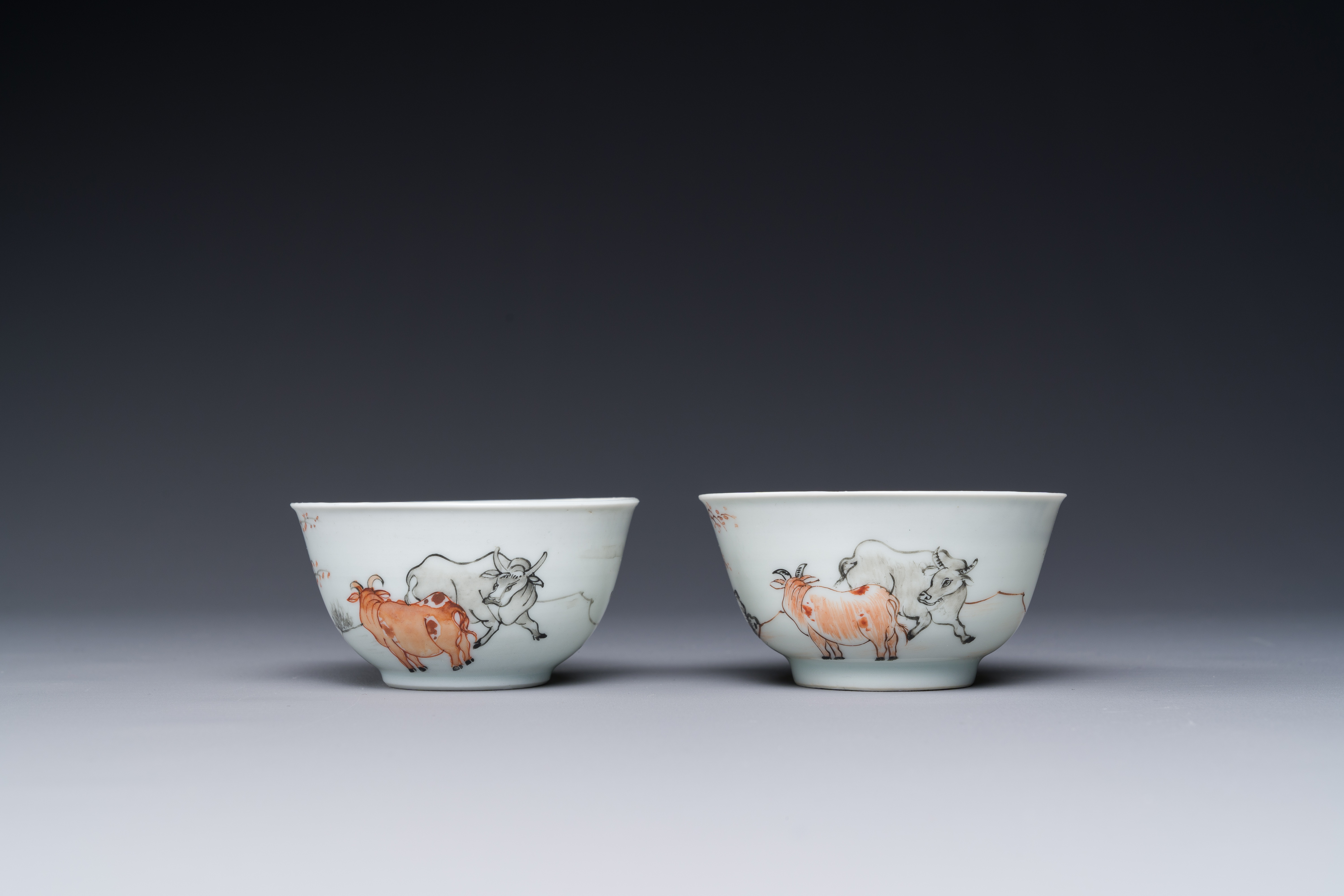A pair of Chinese grisaille and iron-red 'buffalo' cups and saucers and a 'rooster' saucer, Yongzhen - Image 2 of 6