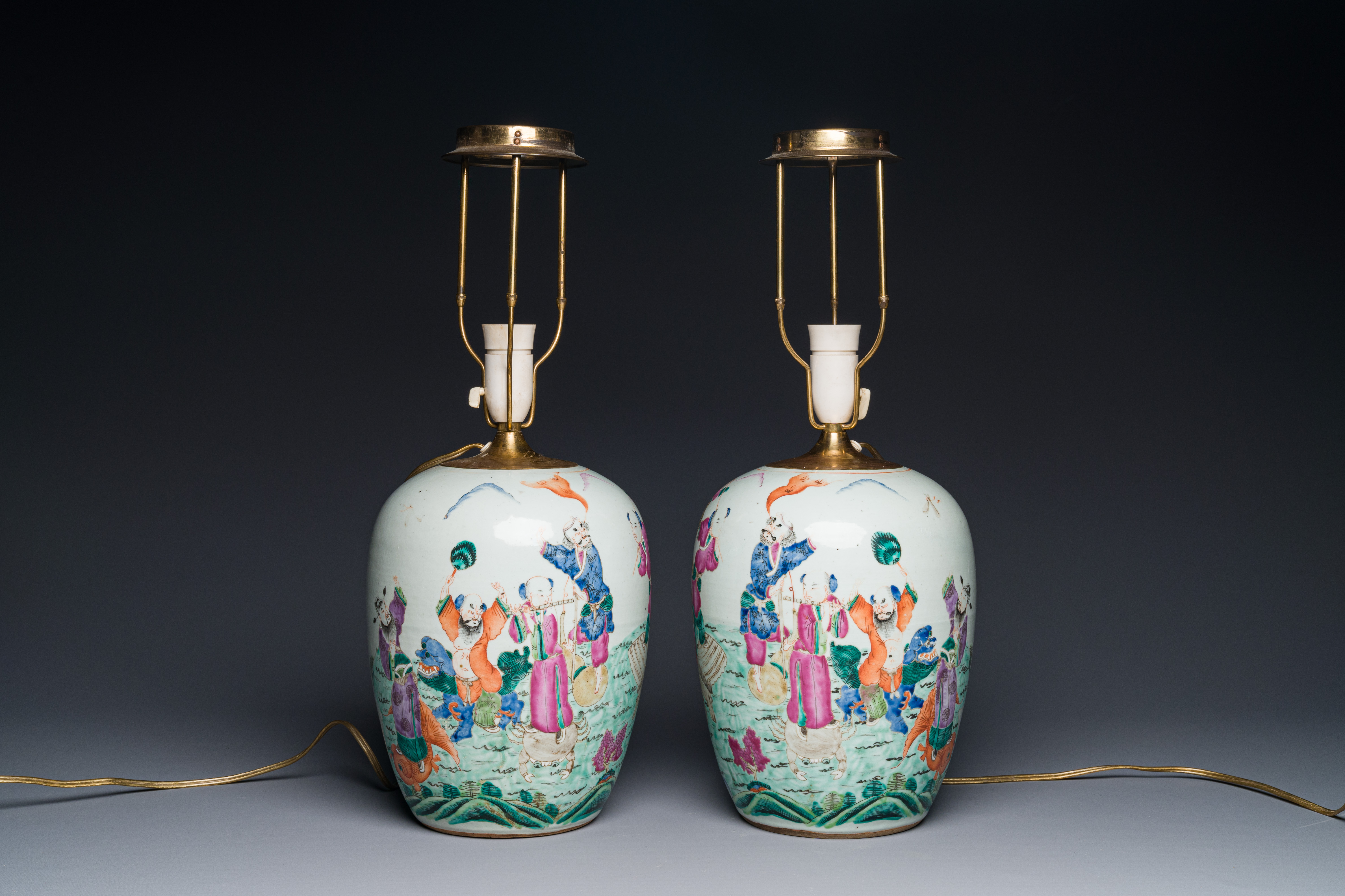 A pair of Chinese famille rose 'eight immortals' jars mounted as lamps, 19th C.