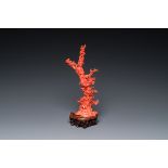 A Chinese red coral sculpture of Xiwangmu standing on a rock, 19/20th C.