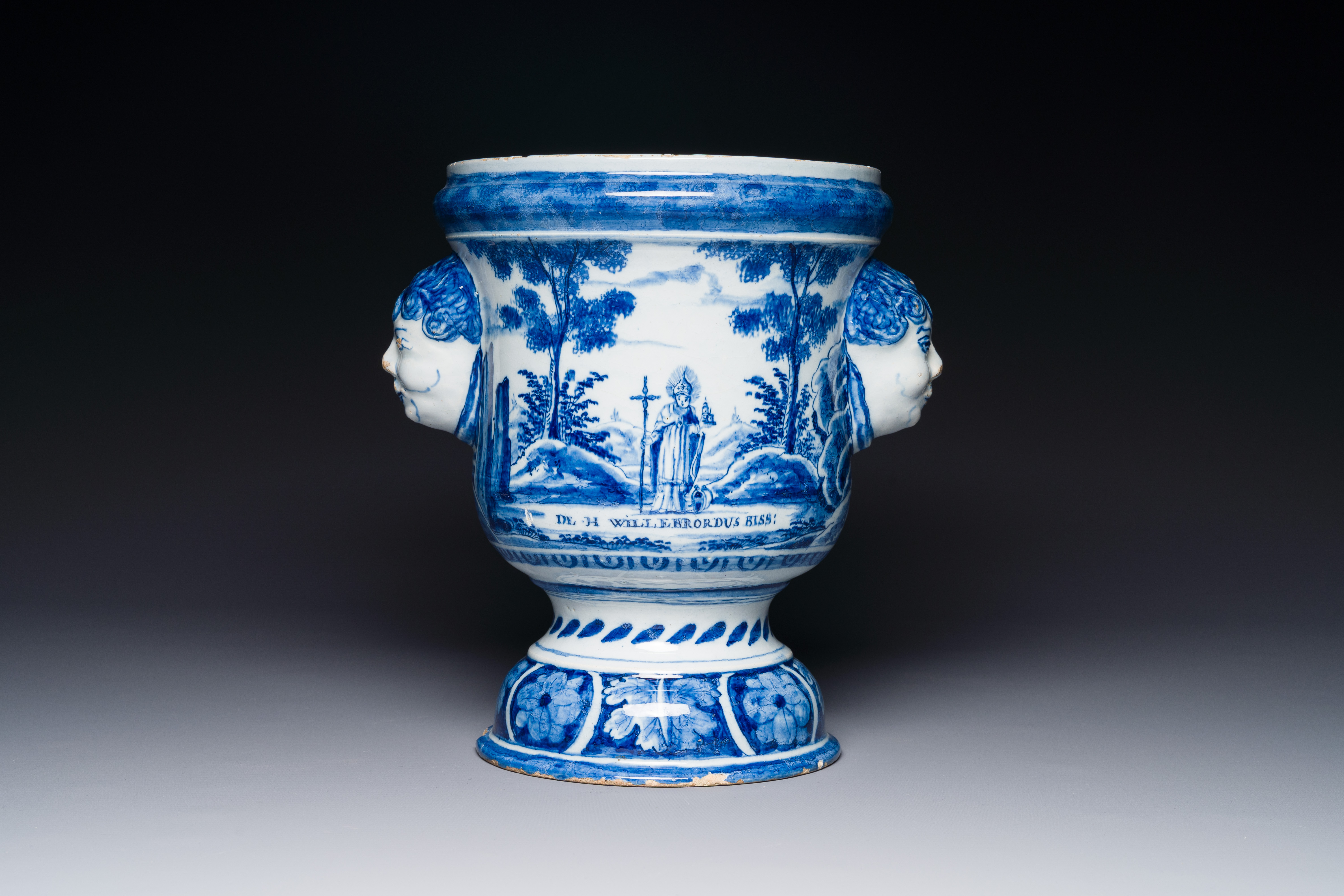 A Dutch Delft blue and white jardiniere depicting Saint Willibrord and John the Baptist, 18th C.