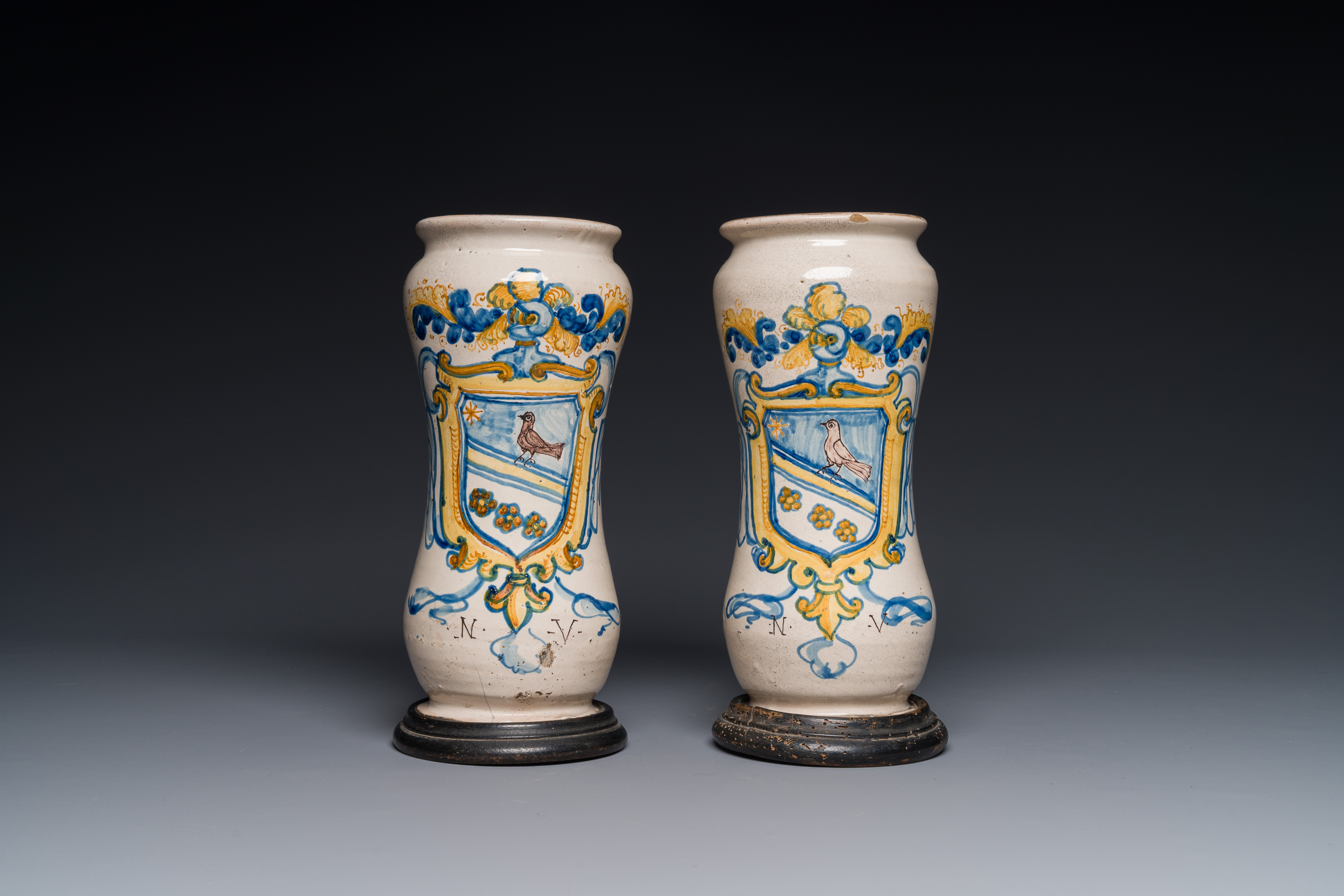 A pair of polychrome Italian maiolica armorial albarelli monogrammed NV, Naples, 2nd half 17th C.