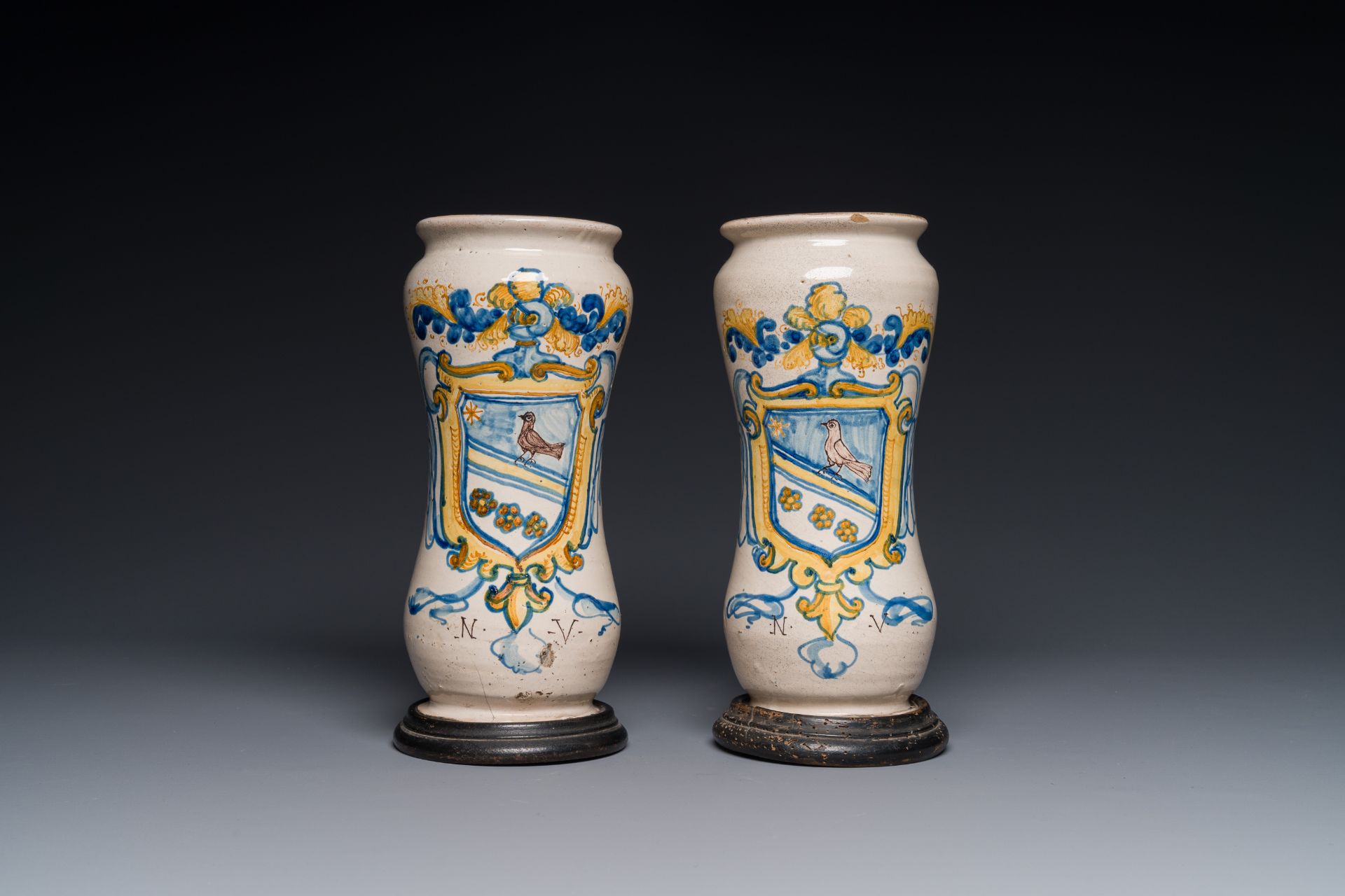 A pair of polychrome Italian maiolica armorial albarelli monogrammed NV, Naples, 2nd half 17th C.