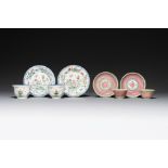 A pair of Chinese famille verte and a pair of famille rose cups and saucers, Kangxi/Yongzheng