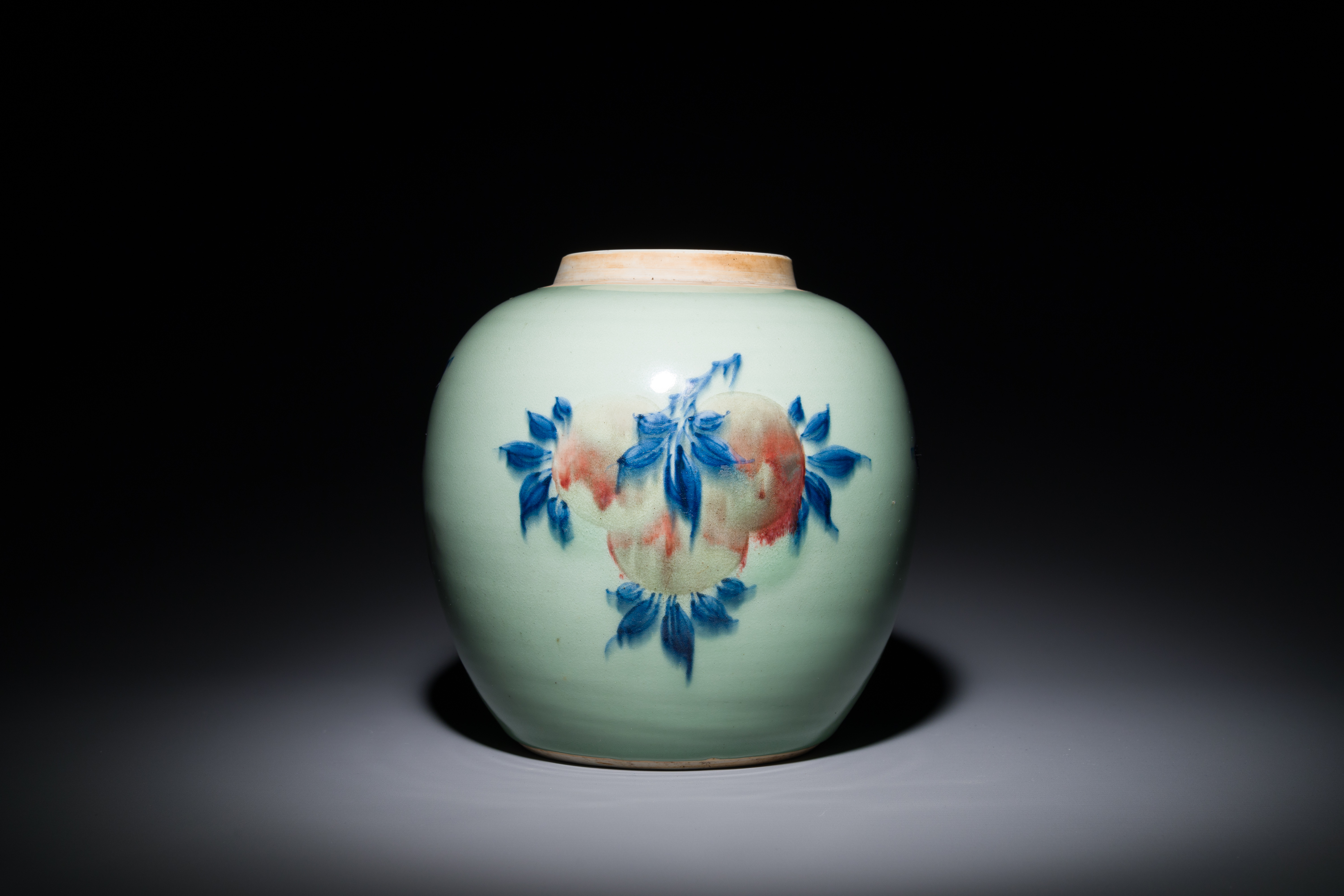 A Chinese celadon-ground blue, white and copper-red ginger jar with wooden cover and stand, 18th C. - Image 3 of 4