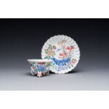 A Chinese famille rose relief-decorated cup and saucer, Yongzheng