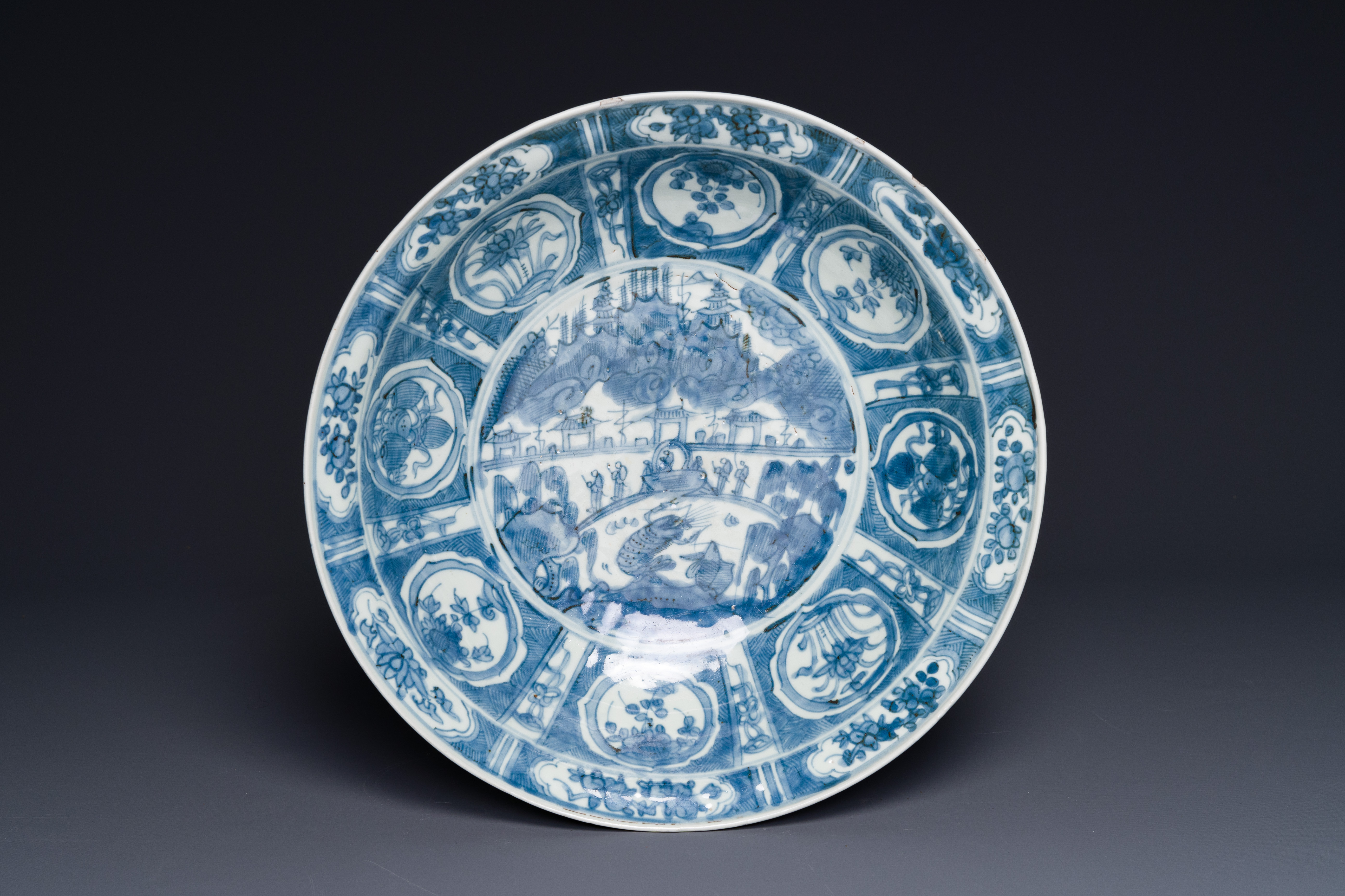 A large Chinese blue and white Swatow dish with a lobster and a carp at a fishing village, Ming