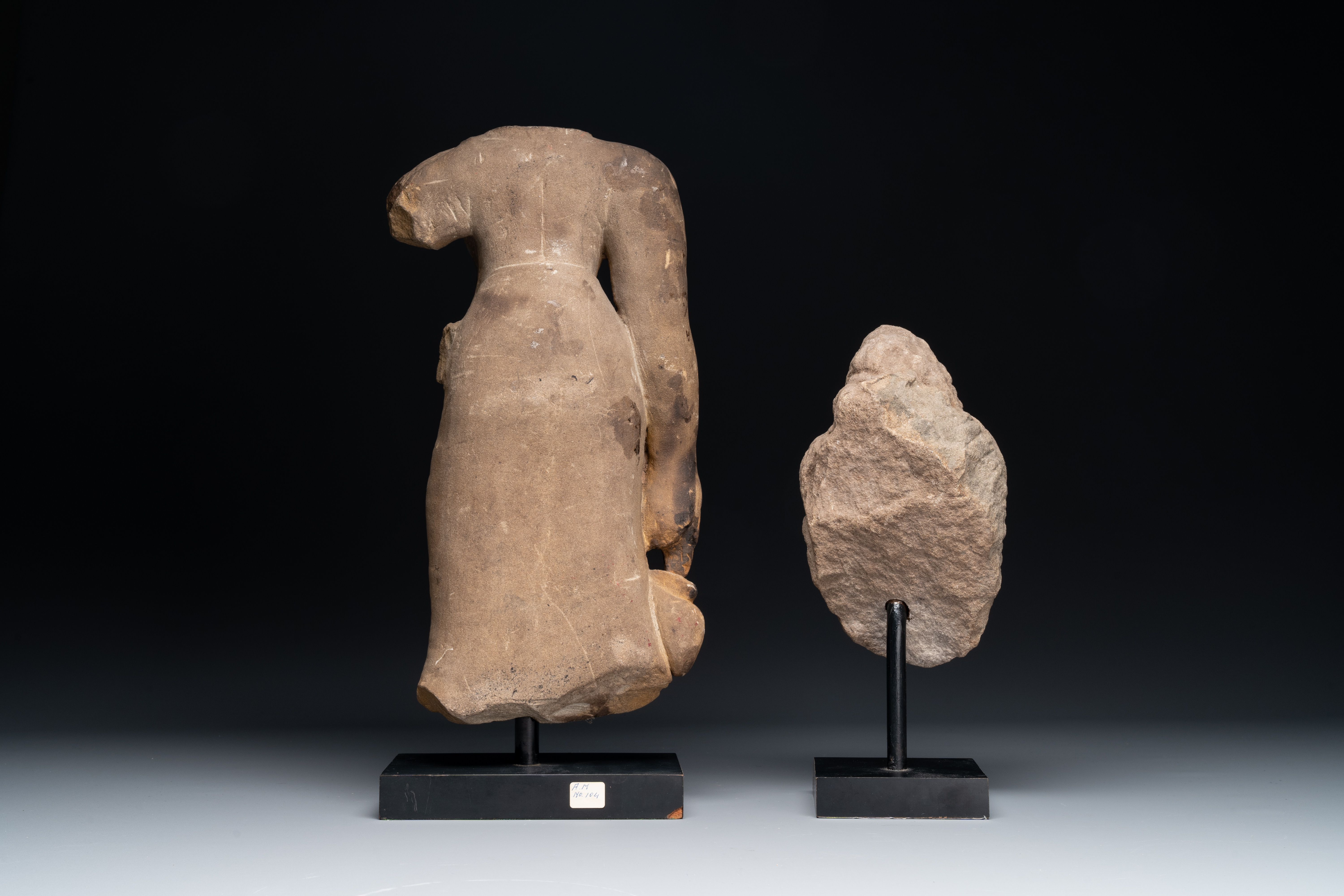 A sandstone female torso and a Buddha head, Cambodia, late Khmer period, 13/14th C. - Image 5 of 6