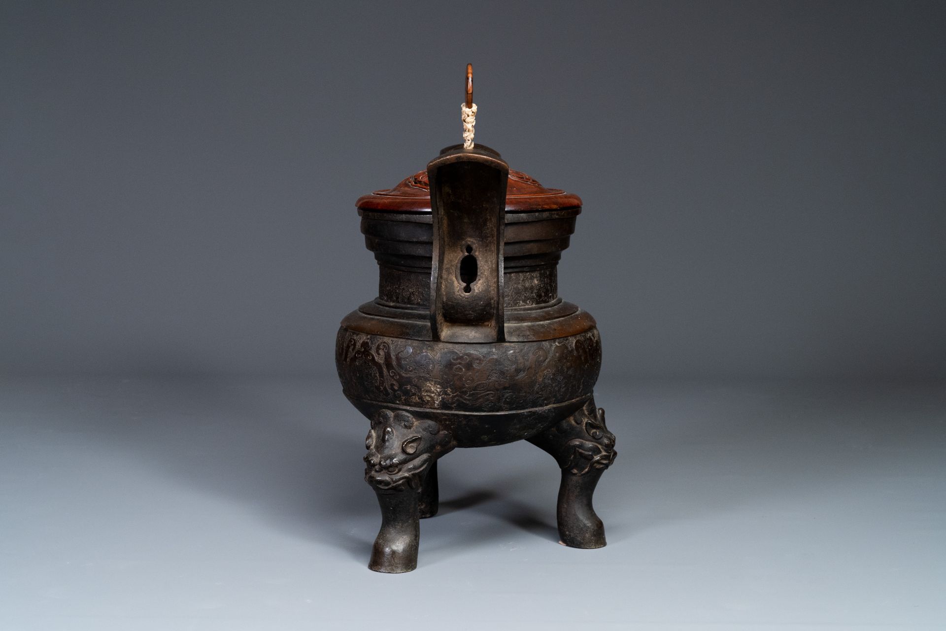 An important Chinese bronze tripod 'taotie' censer with wooden lid, Ming - Image 11 of 18