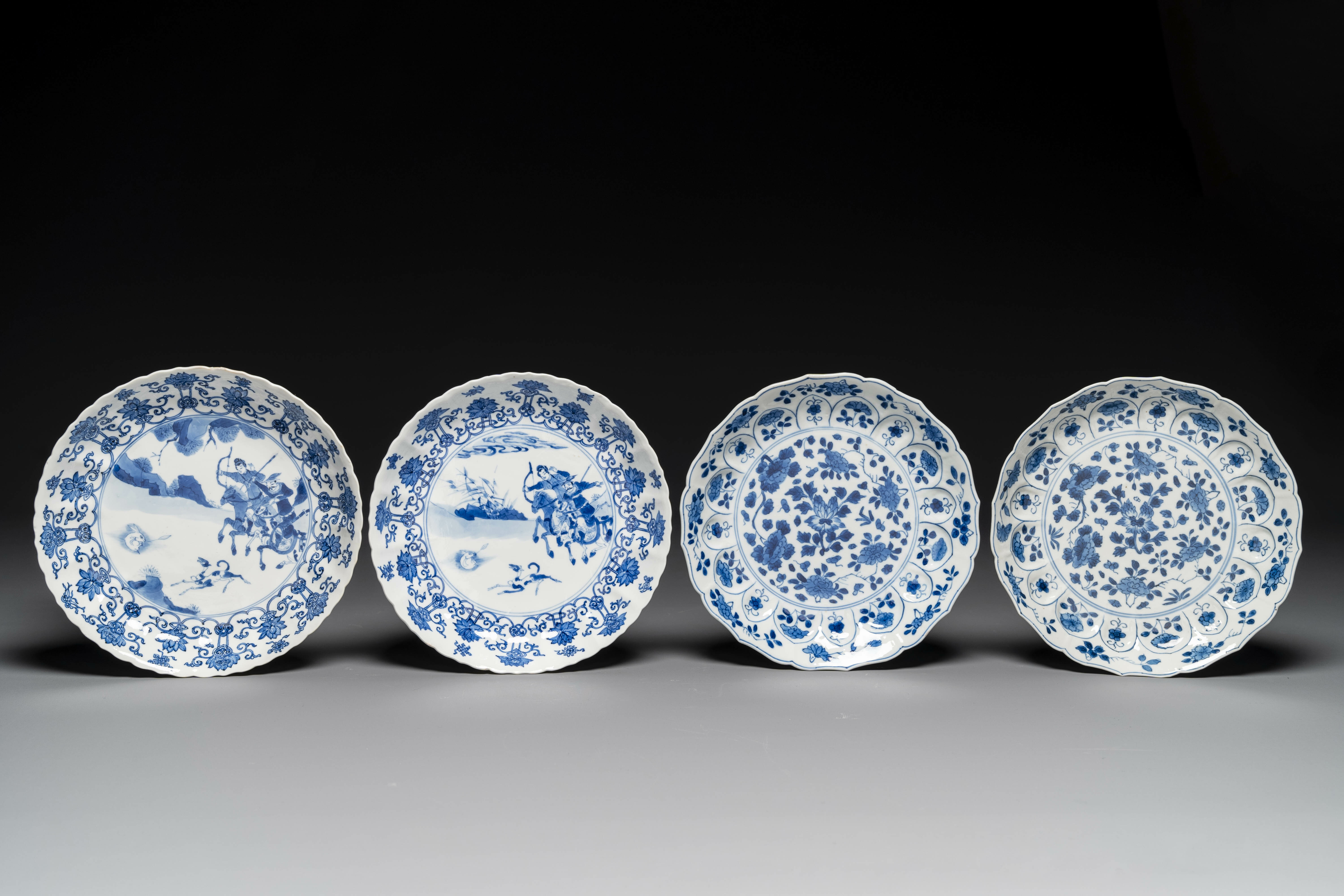 A pair of Chinese blue and white 'Mongolian hunting scene' plates and a pair of plates with floral d