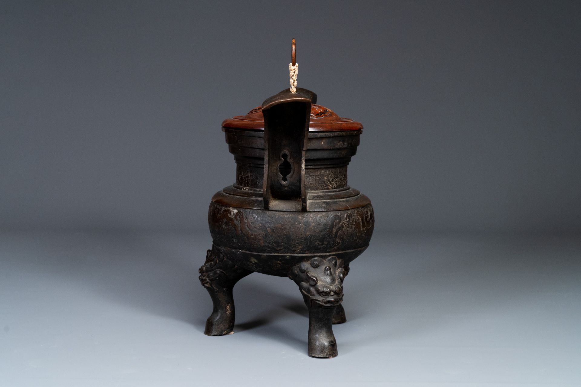 An important Chinese bronze tripod 'taotie' censer with wooden lid, Ming - Image 4 of 18